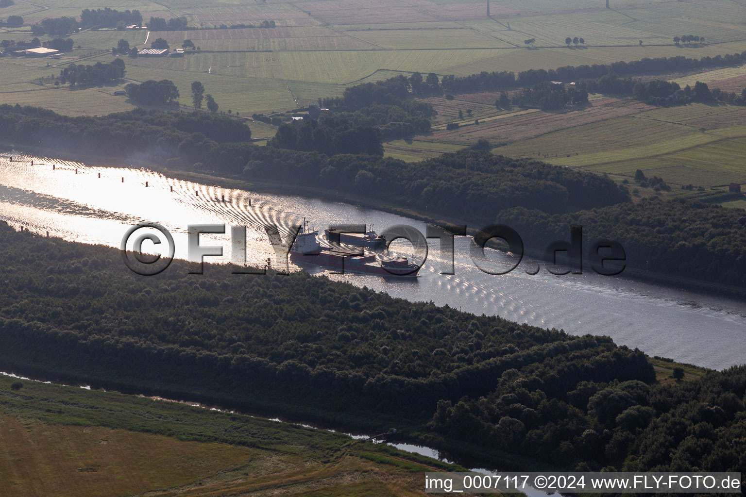 Ride of freight ships in Nord-Ostsee-Kanal in Kudensee in the state Schleswig-Holstein, Germany