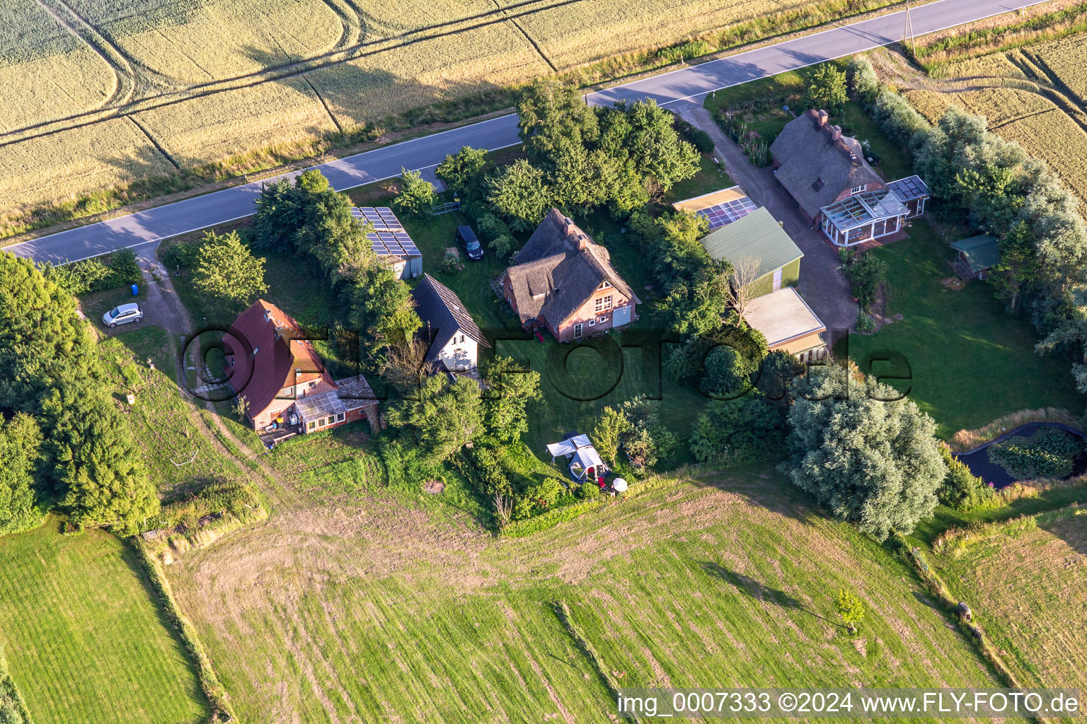 Former dike keepers' yards on Schülpersieler Straße in Wesselburenerkoog in the state Schleswig Holstein, Germany from the plane