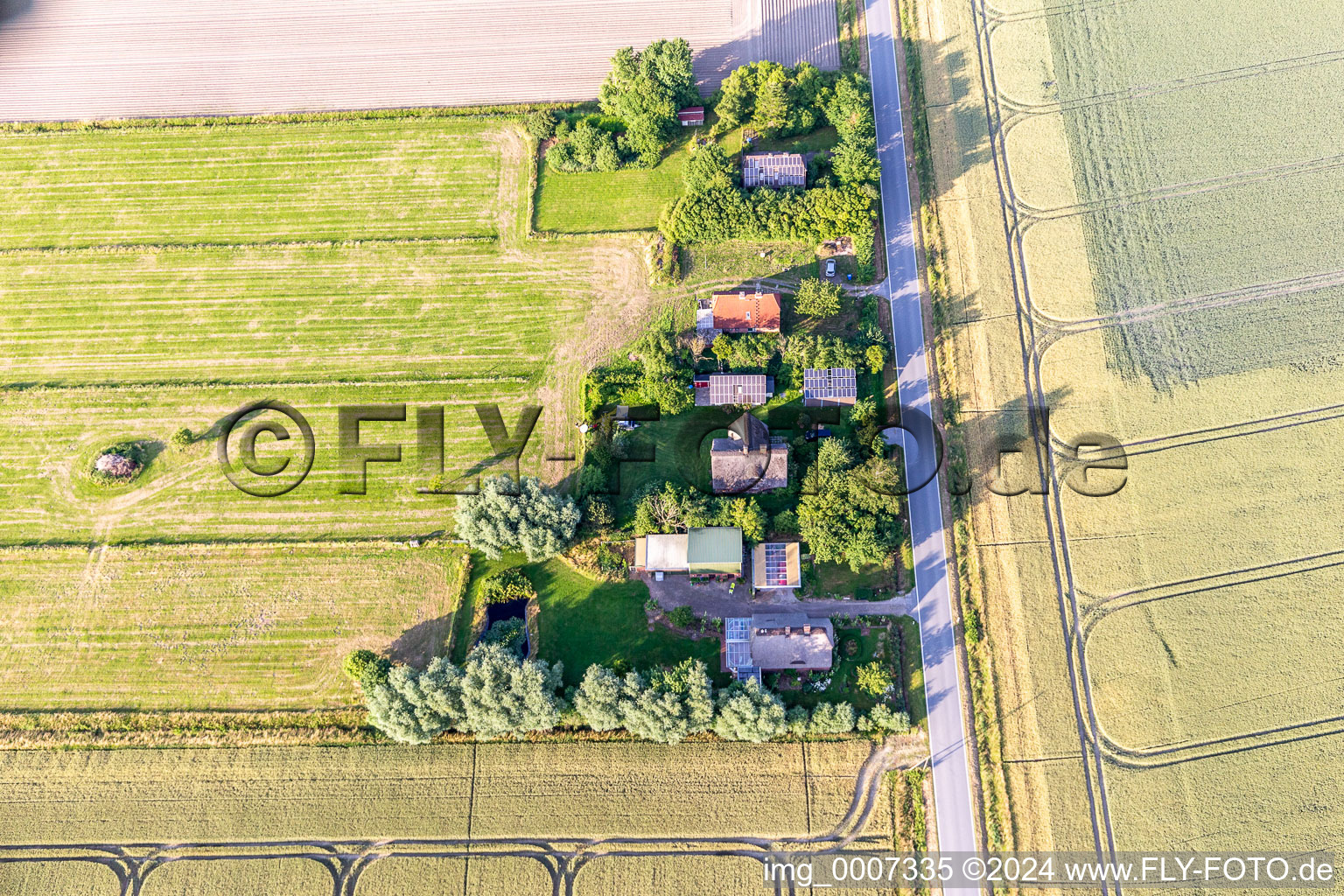 Former dike keeper's farms on Schülpersieler Straße in Wesselburenerkoog in the state Schleswig Holstein, Germany viewn from the air