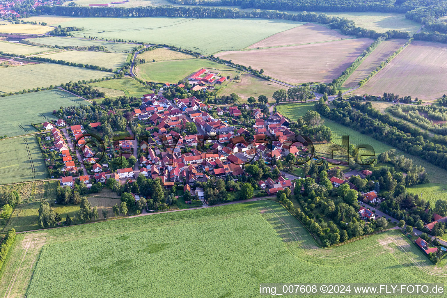 Agricultural land and field boundaries surround the settlement area of the village in Gospiteroda in the state Thuringia, Germany