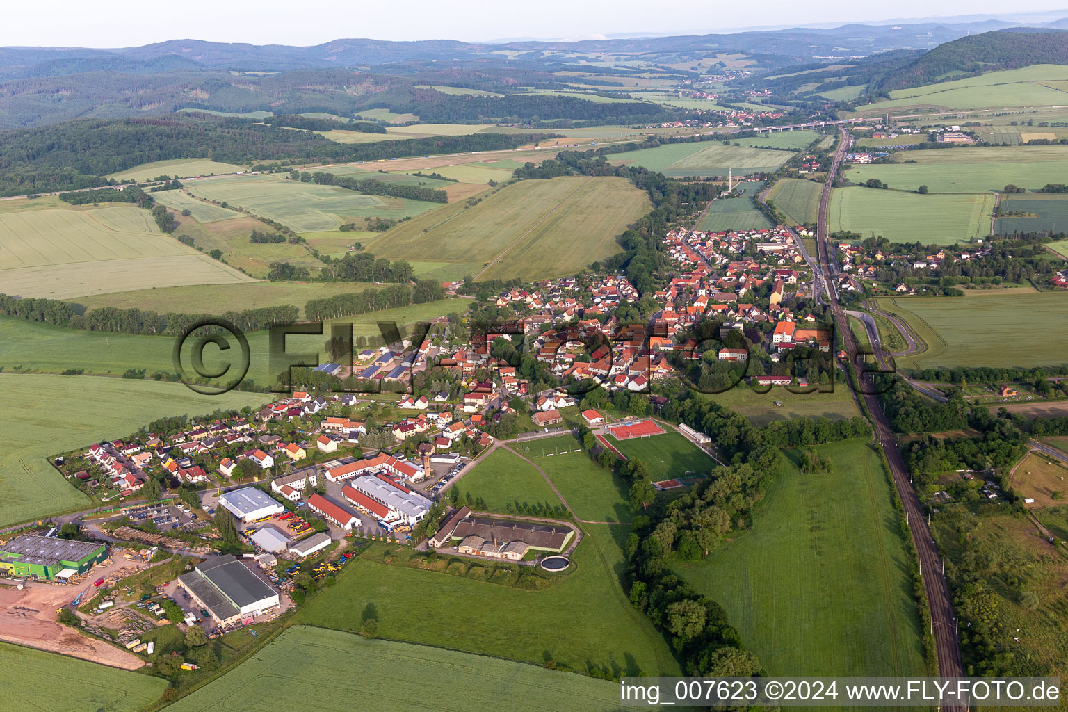 Agricultural land and field boundaries surround the settlement area of the village in Mechterstaedt in the state Thuringia, Germany