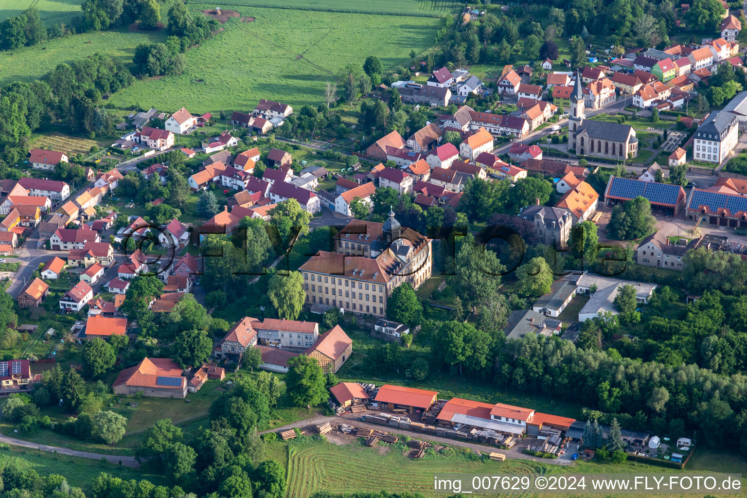 Aerial view of Village view on the edge of agricultural fields and land in Friedrichswerth in the state Thuringia, Germany