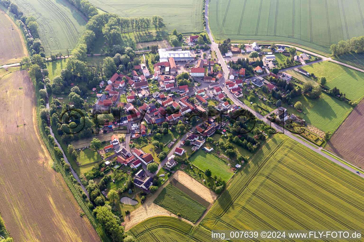 Agricultural land and field boundaries surround the settlement area of the village in Eberstaedt in the state Thuringia, Germany