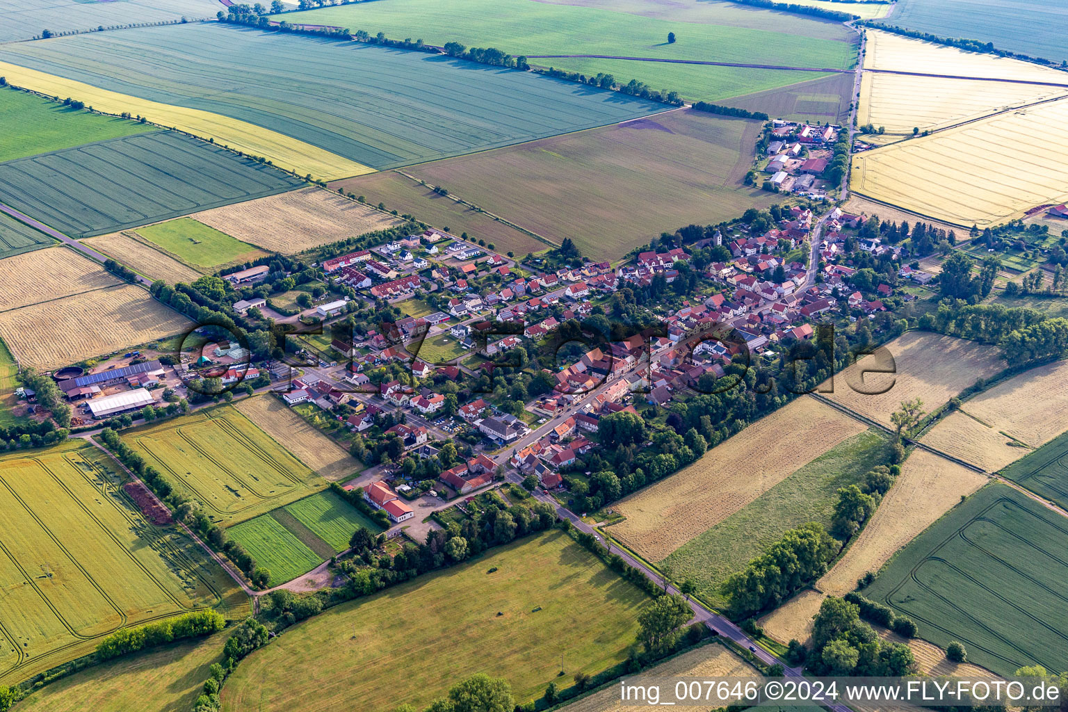 Agricultural land and field boundaries surround the settlement area of the village in Westhausen in the state Thuringia, Germany