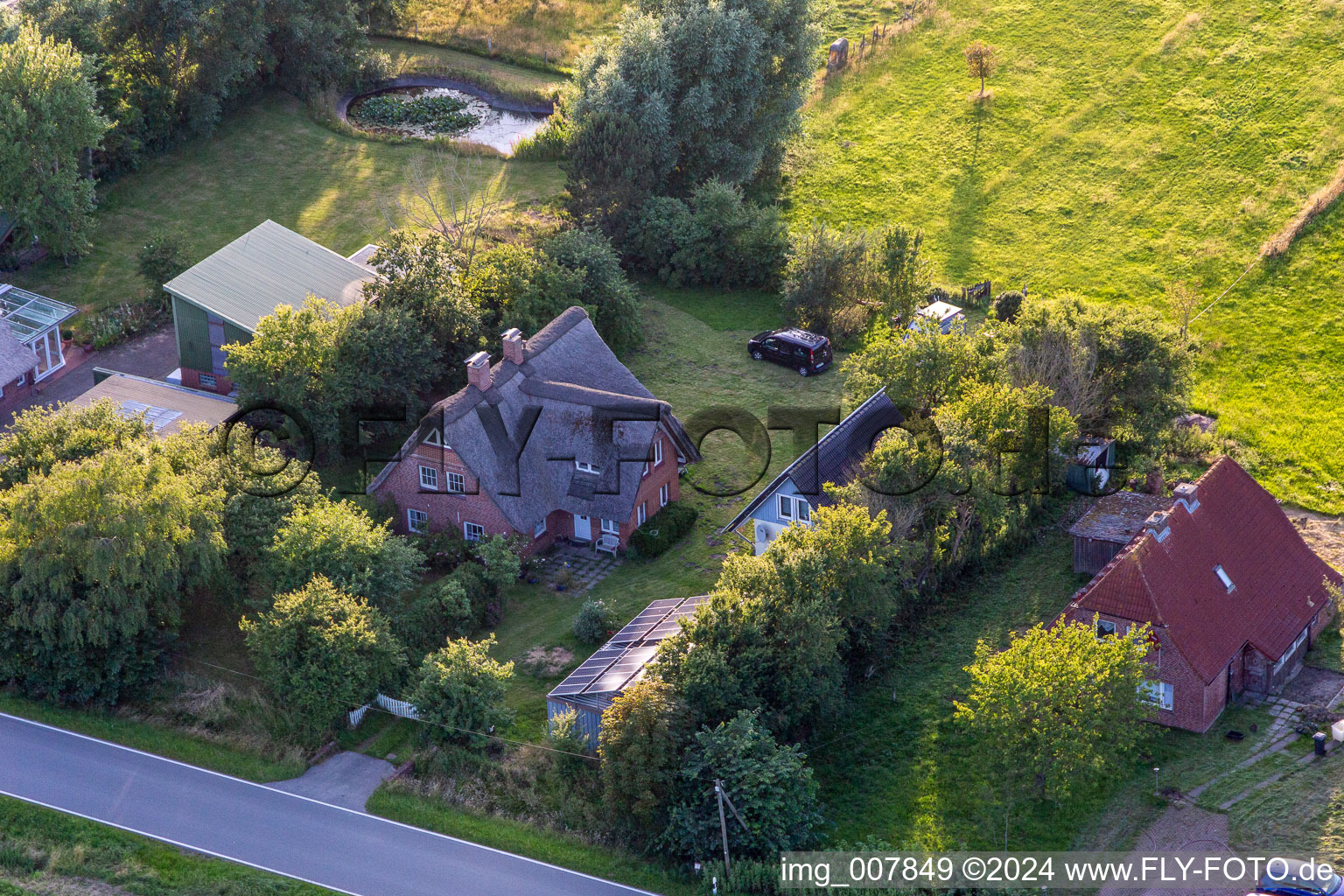 Schülpersieler Street in Wesselburenerkoog in the state Schleswig Holstein, Germany from a drone