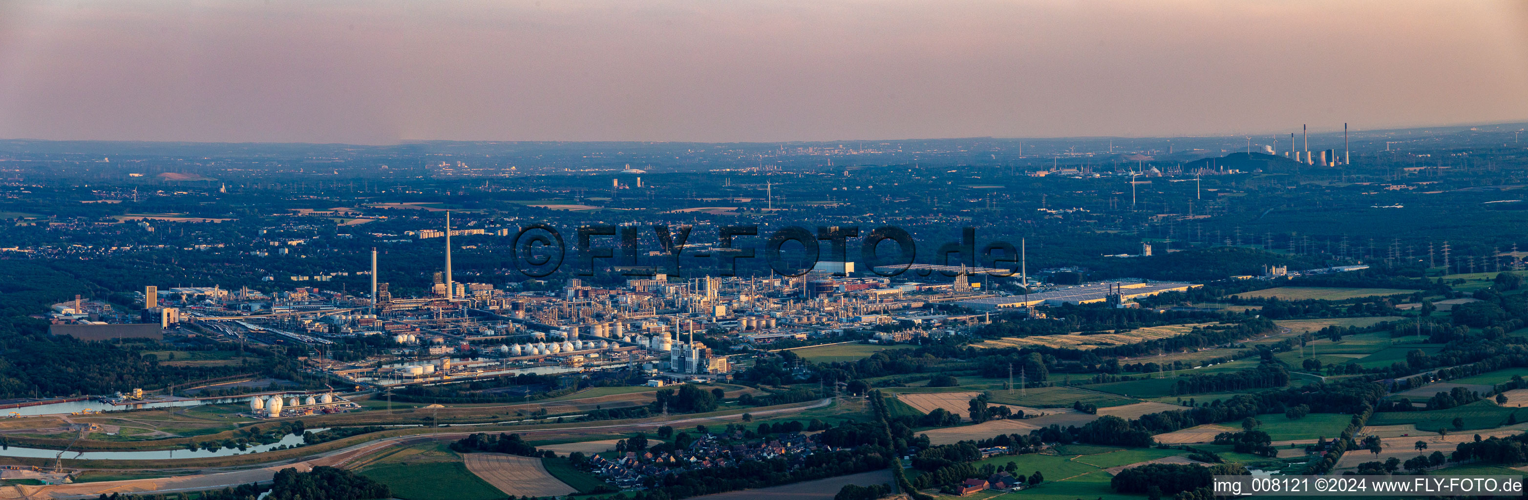 Panoramic perspective of the building and production halls on the premises of the chemical manufacturers Chemiepark Marl on Paul-Baumann Strasse during dawn in Marl in the state North Rhine-Westphalia, Germany