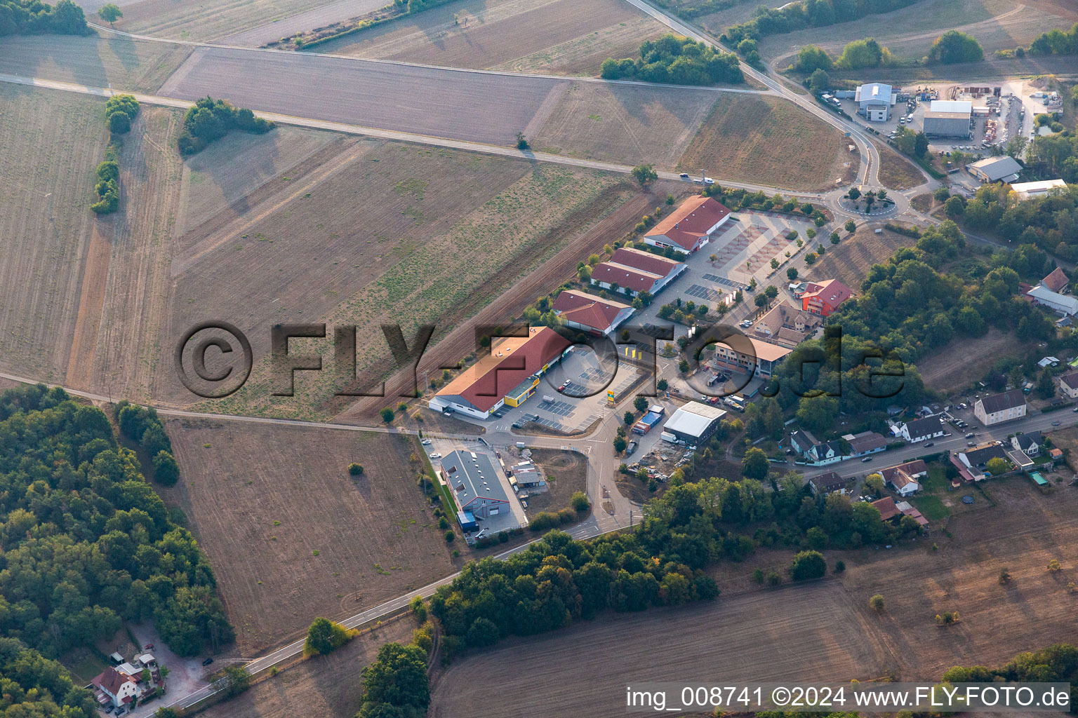 Buildings of the shopping center Muehlaecker with Netto Filiale, TEDi, PENNY, DEICHMANN and Bau-Solar Suedwest GmbH for the French customers in Neulauterburg in the state Rhineland-Palatinate, Germany