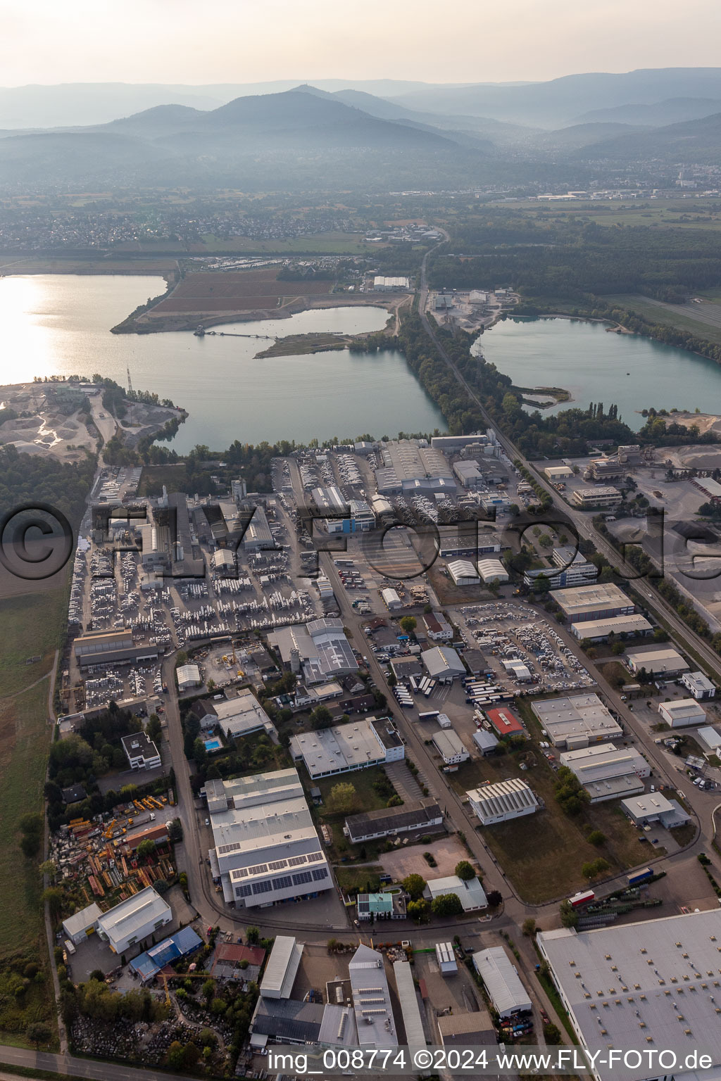 Aerial view of Industrial and commercial area Ost on Kuehlsee with ELMAKO GmbH & Co. KG, Kronimus AG Betonsteinwerk, IKE Iffezheimer Kies- and Edelsplittwerk Max Kern GmbH & Co. KG,BKG Transportbeton GmbH + Co. KG and SWA Suedwest Asphalt GmbH & Co. KG in Iffezheim in the state Baden-Wuerttemberg, Germany