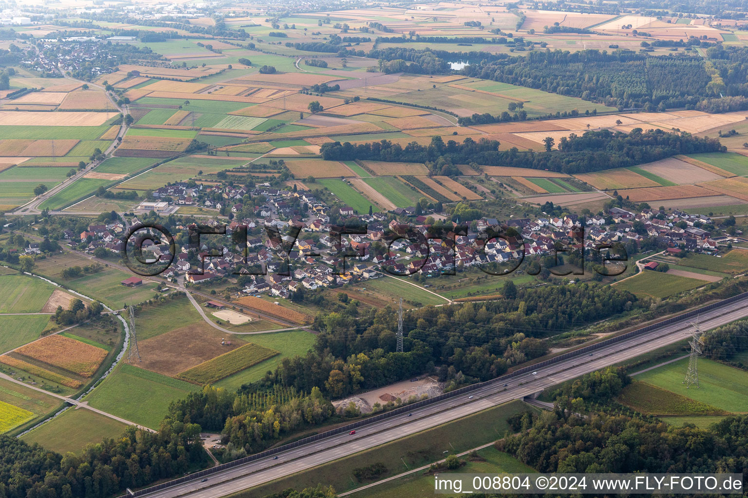 Agricultural land and field borders surround the settlement area of the village behind the motorway A5 in Balzhofen in the state Baden-Wuerttemberg, Germany