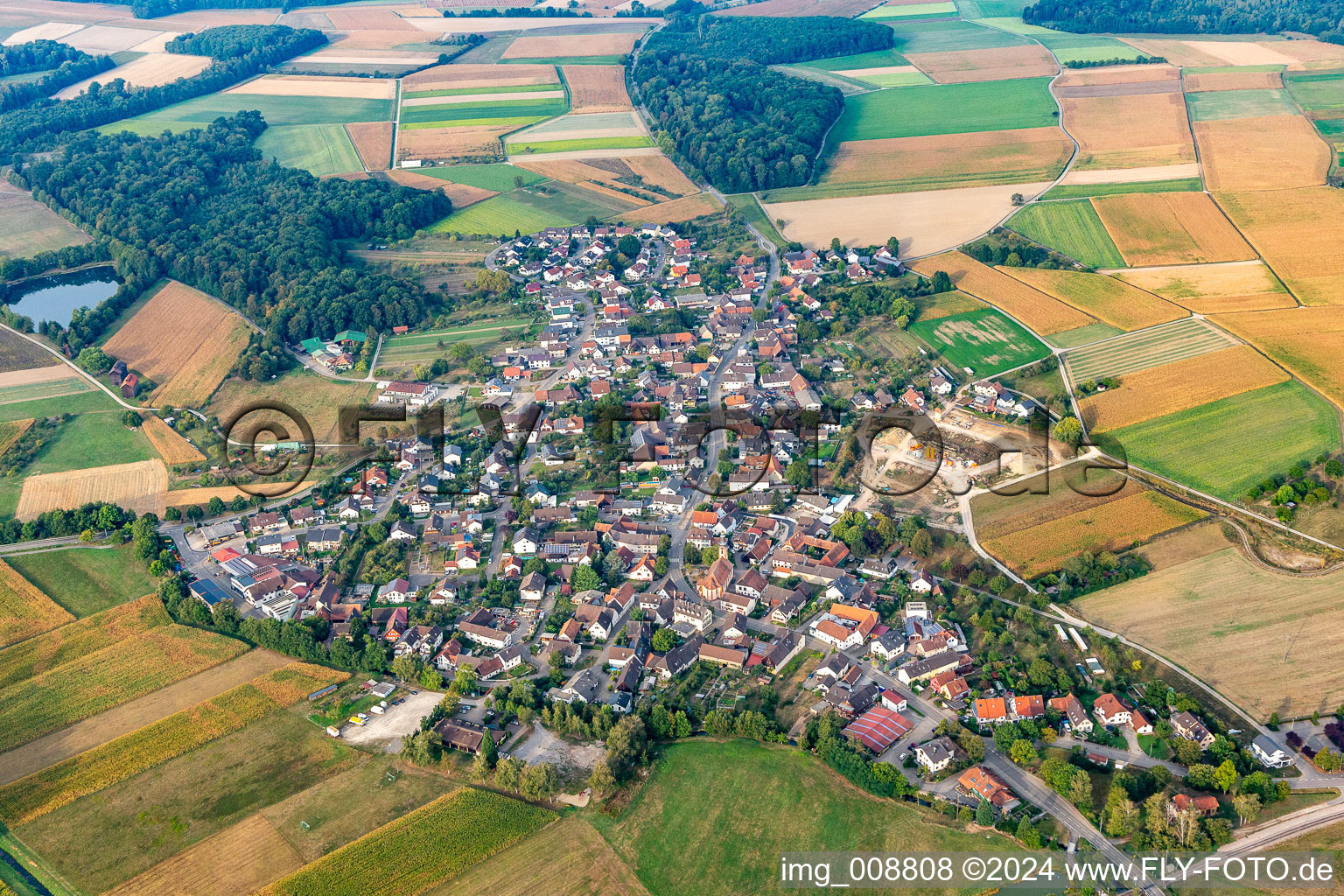 Aerial view of Agricultural land and field borders surround the settlement area of the village in Moos in the state Baden-Wuerttemberg, Germany