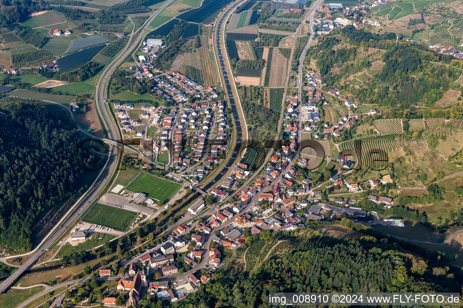 Location view of the streets and houses of residential areas in the valley landscape surrounded by mountains in Lautenbach in the state Baden-Wuerttemberg, Germany