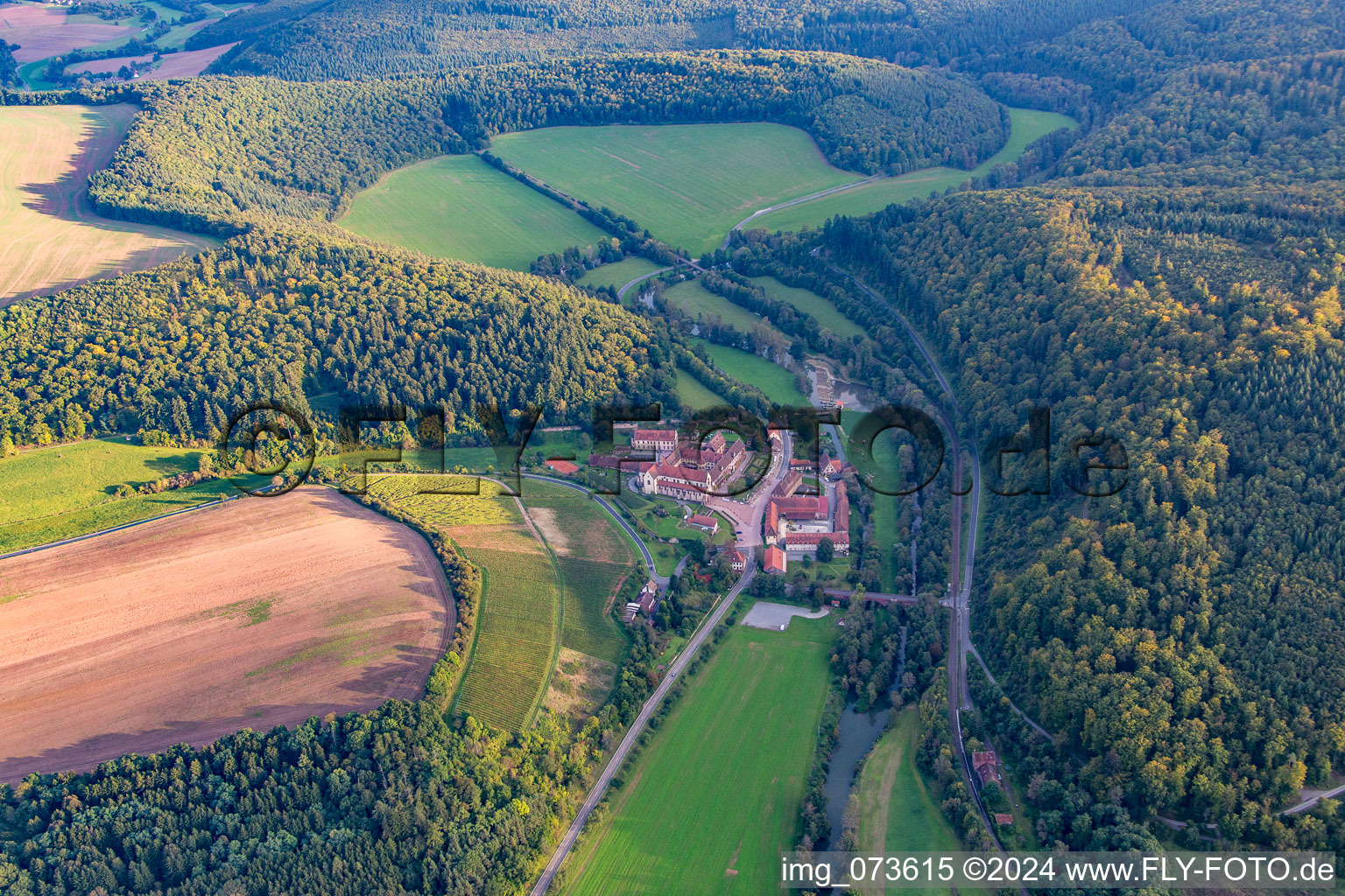 Aerial photograpy of Complex of buildings of the monastery Bronnbach with garden and Church Mariae Himmelfahrt in Wertheim in the state Baden-Wurttemberg, Germany