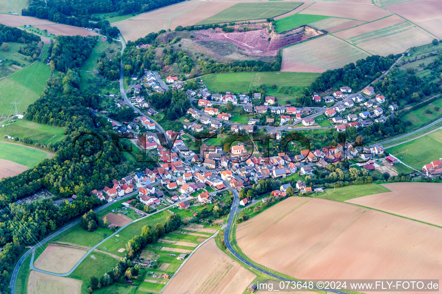 Village - view on the edge of agricultural fields and farmland in Wuestenzell in the state Bavaria, Germany