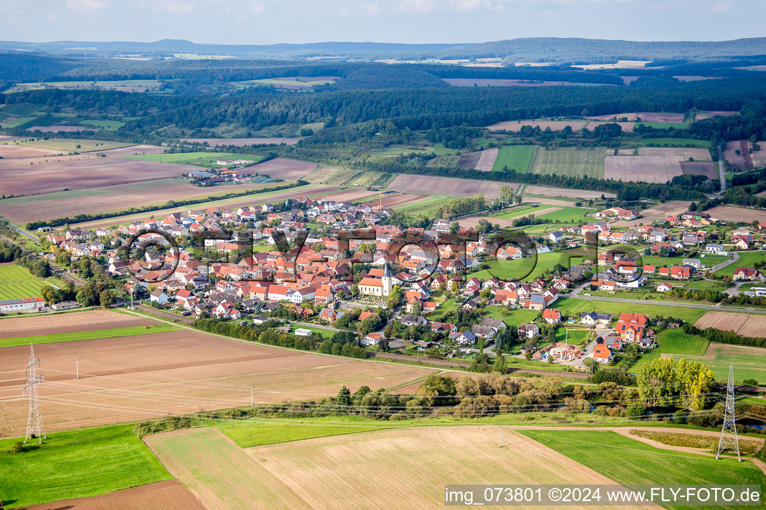 Village - view on the edge of agricultural fields and farmland in Staffelbach in the state Bavaria, Germany