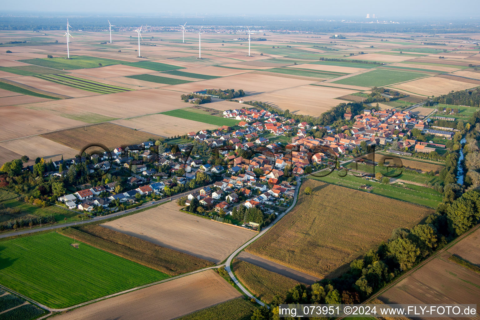 Village - view on the edge of Windmills and agricultural fields and farmland in Herxheimweyher in the state Rhineland-Palatinate, Germany