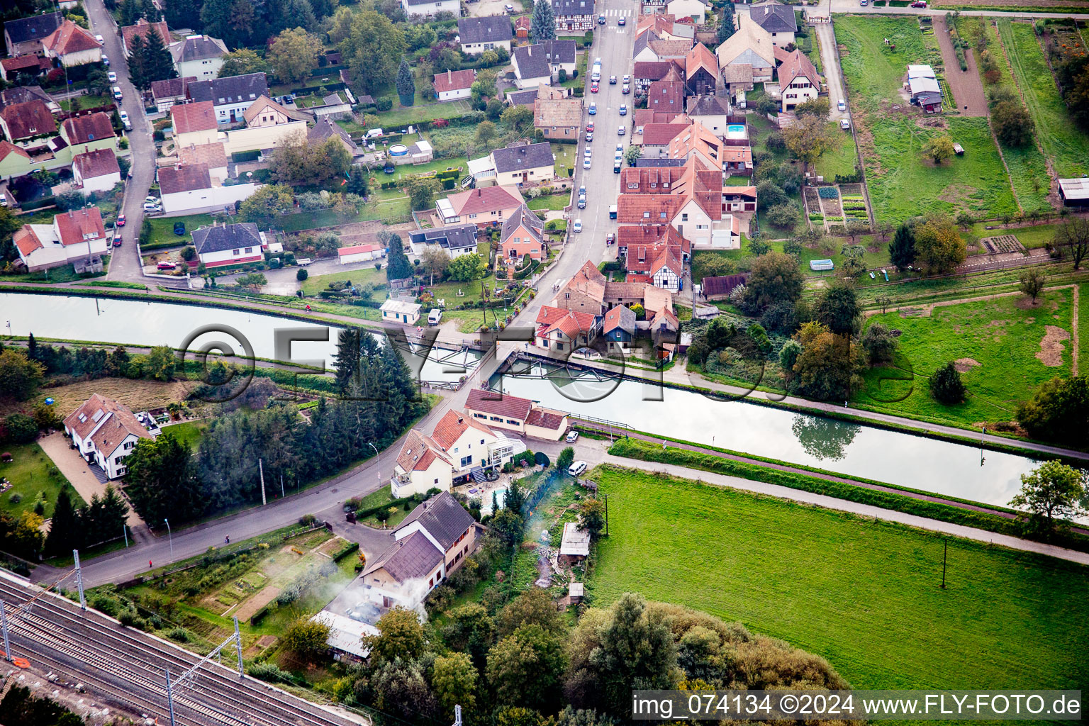 Aerial view of River - bridge construction crossing the Muehlbach in Vendenheim in Grand Est, France