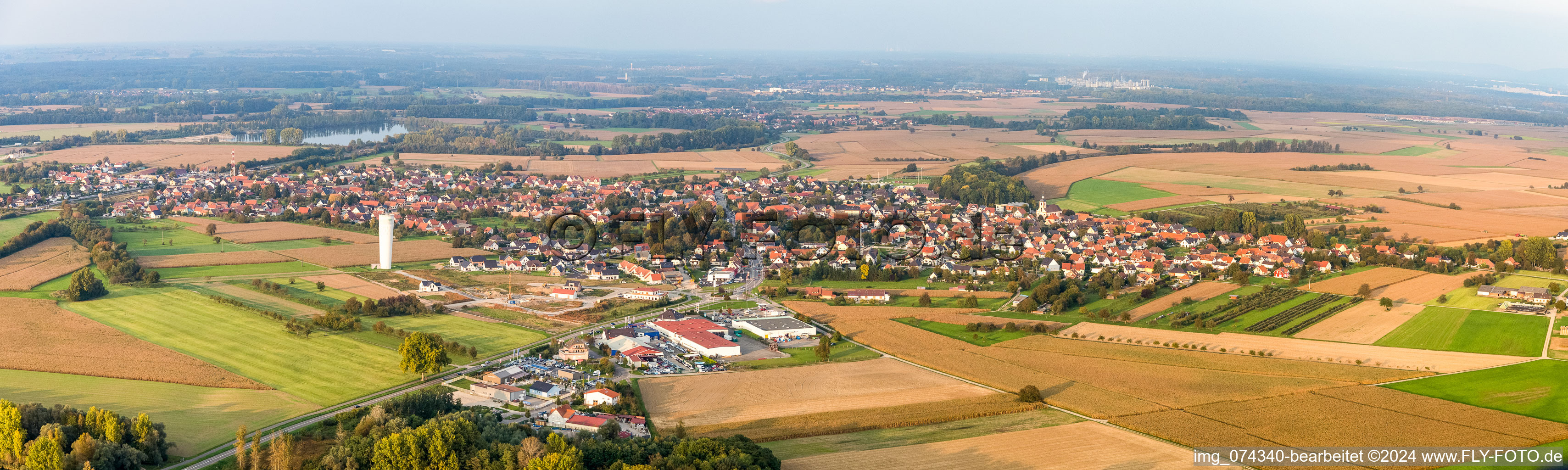 Panoramic perspective Village - view on the edge of agricultural fields and farmland in Roeschwoog in Grand Est, France