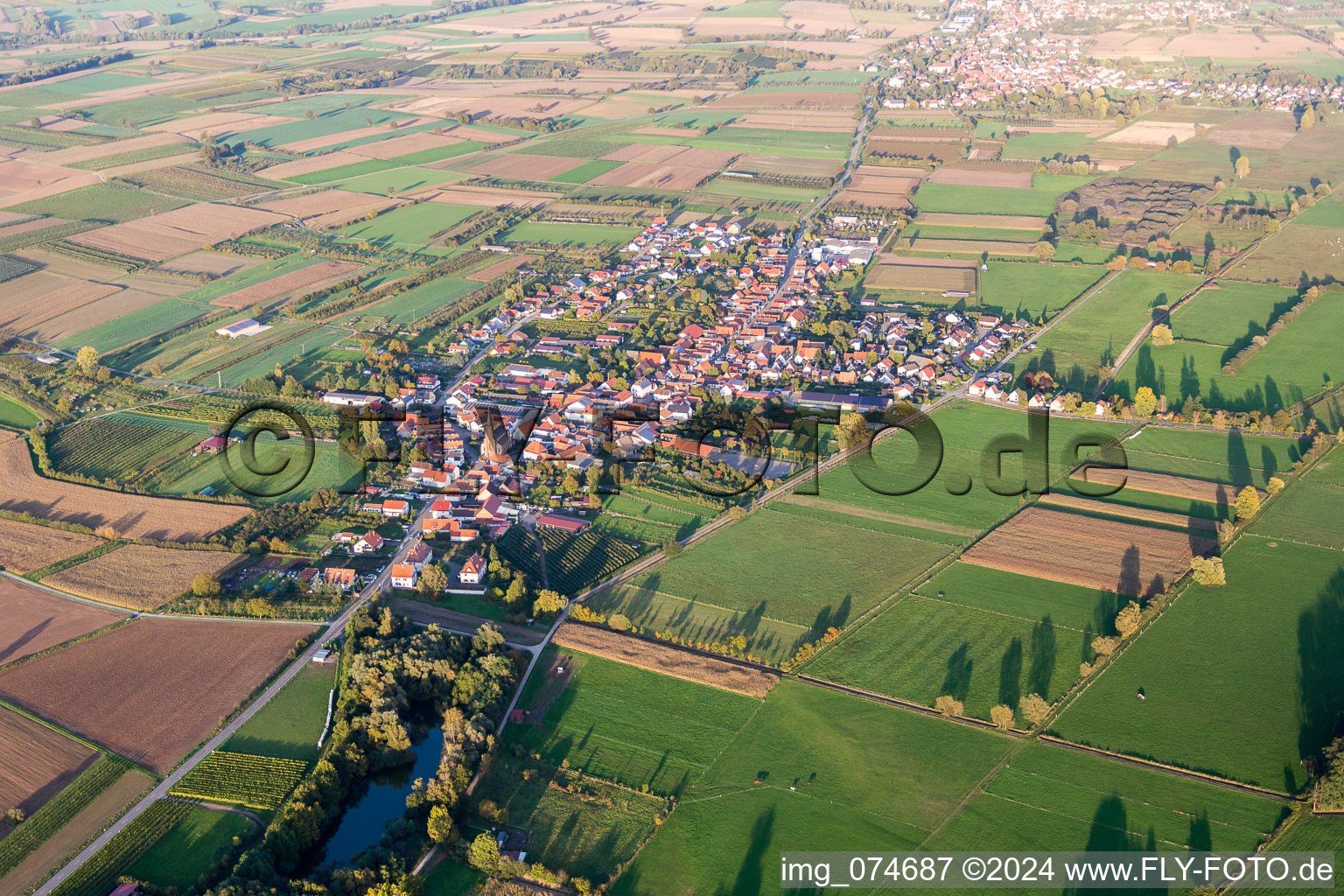 Village - view on the edge of agricultural fields and farmland in Schweighofen in the state Rhineland-Palatinate, Germany