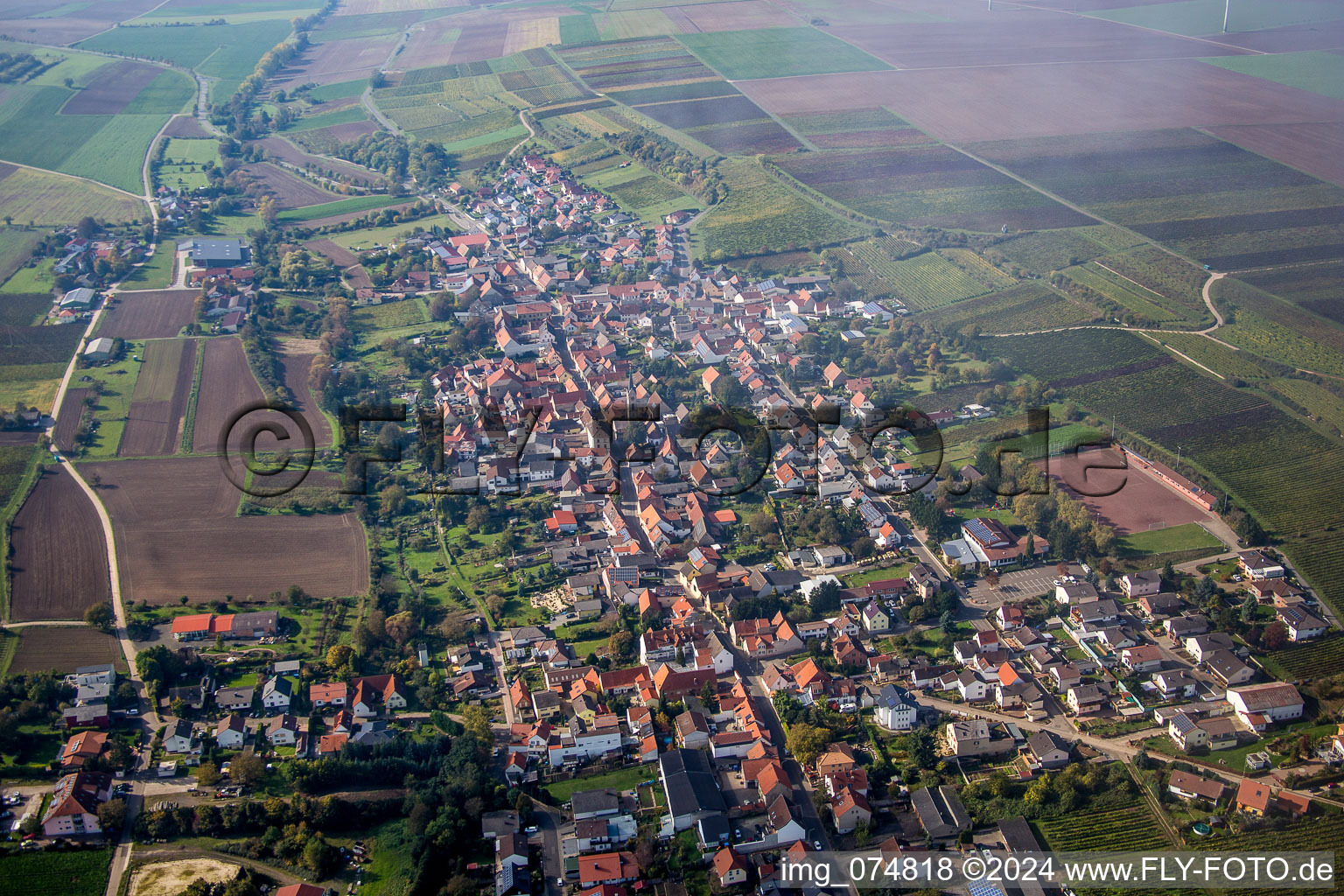 Village - view on the edge of agricultural fields and farmland in Kindenheim in the state Rhineland-Palatinate, Germany