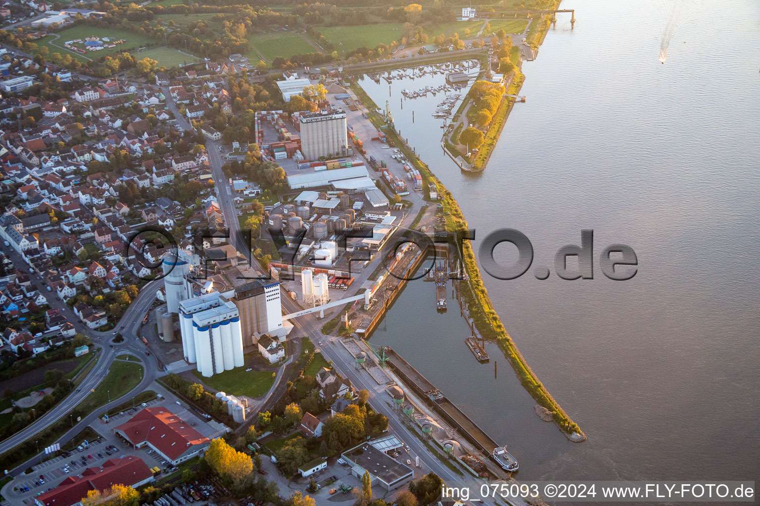 Quays and boat moorings at the port of the inland port of the Rhine river with Anker Memorial Gernsheim in Gernsheim in the state Hesse, Germany