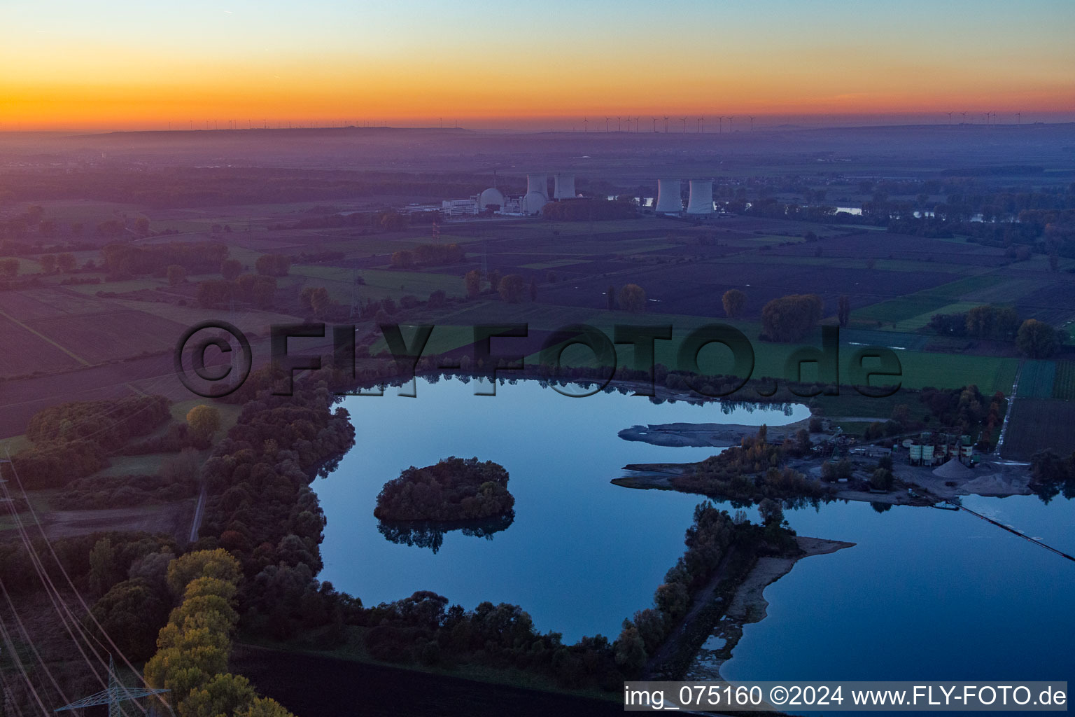 Aerial view of Nuclear power plant behind quarry lake in Groß-Rohrheim in the state Hesse, Germany