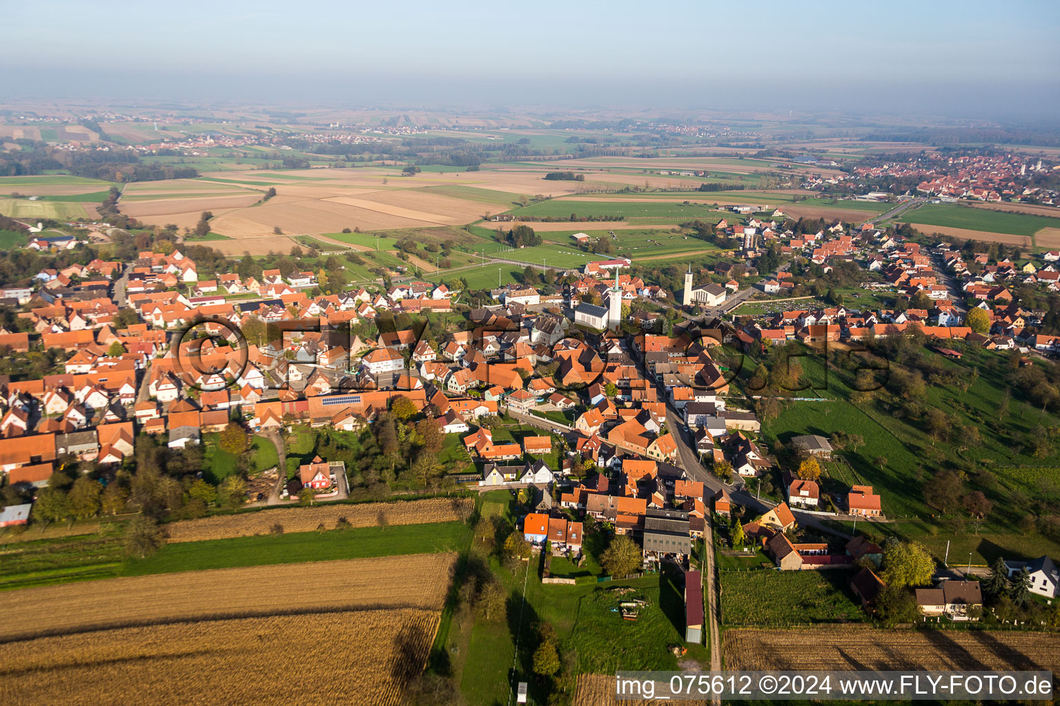 Village - view on the edge of agricultural fields and farmland in Rittershoffen in Grand Est, France