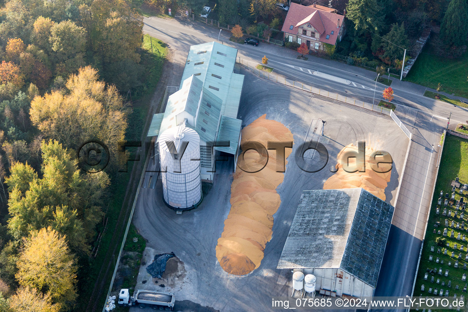 Piles of Mais on the court yard of High silo and grain storage with adjacent storage Comptoir agricole - NIEDERROEDERN in NiederrA?dern in Grand Est, France