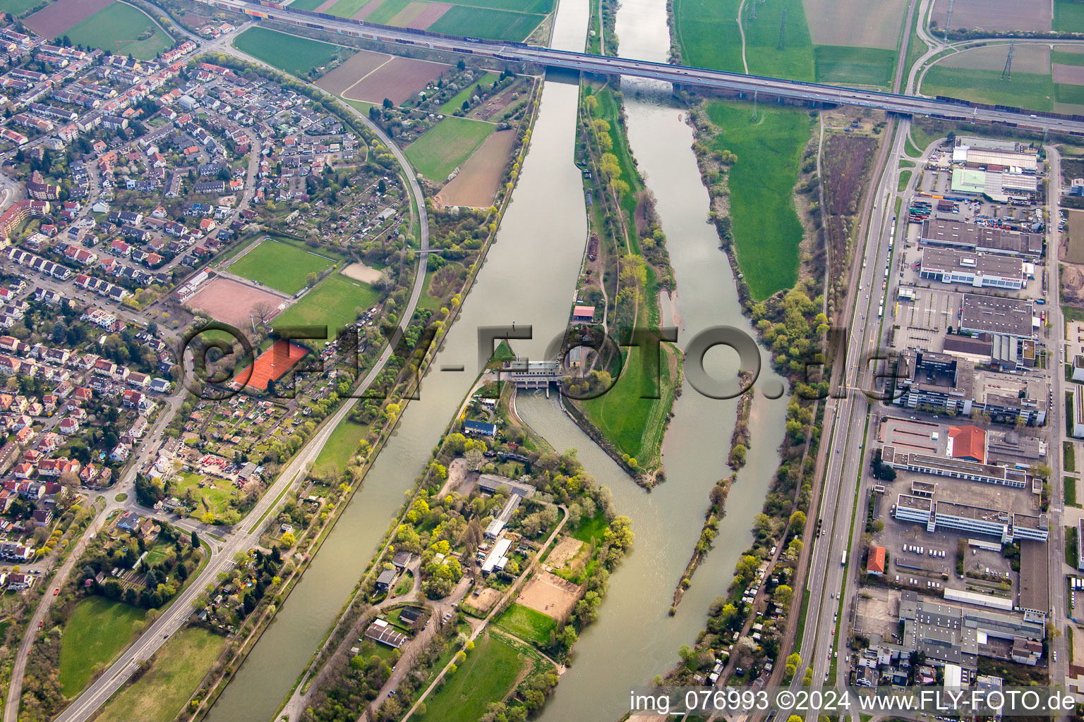 Island on the banks of the river course of Neckar in front of motorway bridge of the A6 in the district Feudenheim in Mannheim in the state Baden-Wurttemberg, Germany