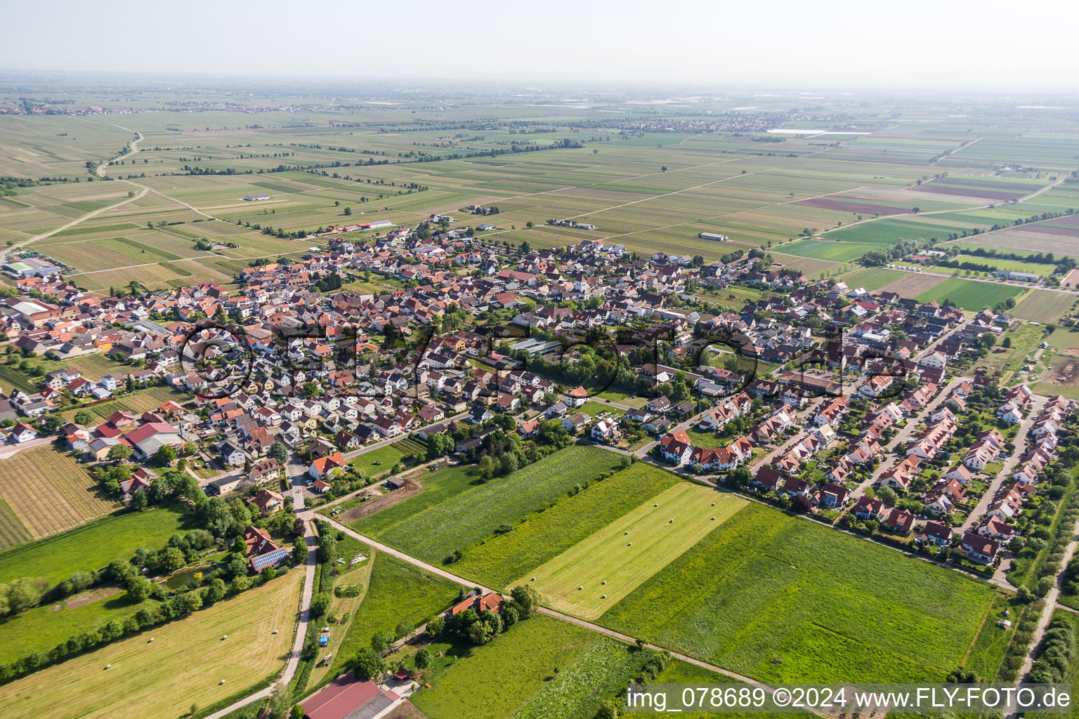 Village - view on the edge of agricultural fields and farmland in Niederkirchen bei Deidesheim in the state Rhineland-Palatinate, Germany