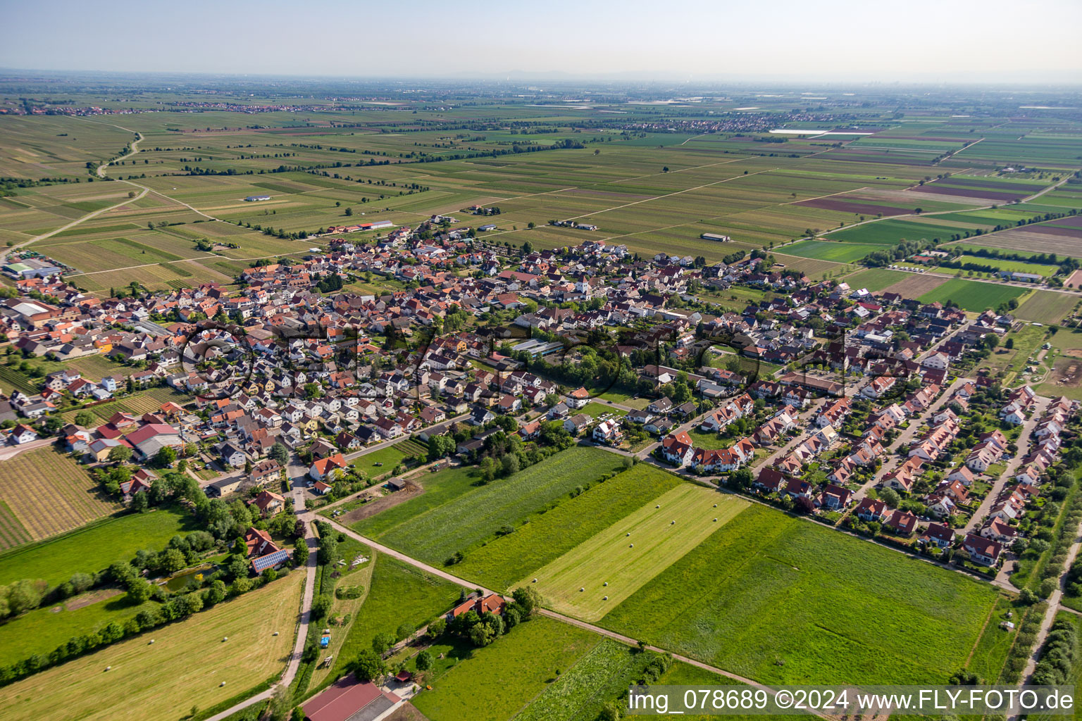 Village - view on the edge of agricultural fields and farmland in Niederkirchen bei Deidesheim in the state Rhineland-Palatinate, Germany