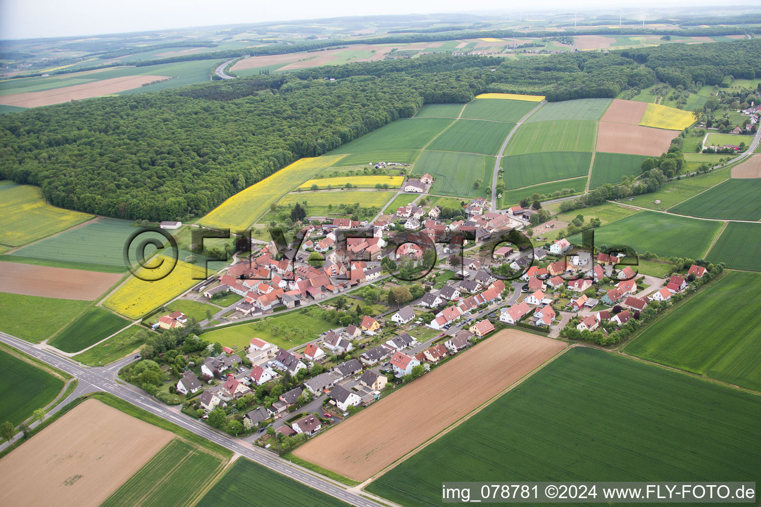 Village - view on the edge of agricultural fields and farmland in the district Eckartshausen in Werneck in the state Bavaria