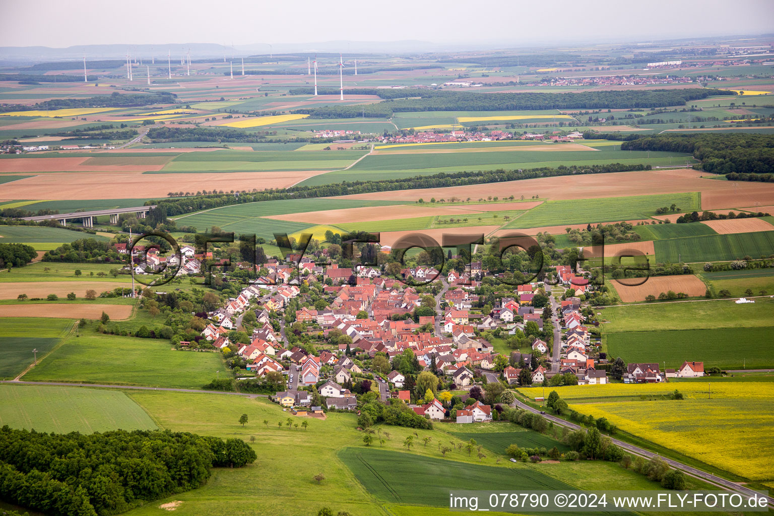 Village - view on the edge of agricultural fields and farmland in Vasbuehl in the state Bavaria, Germany