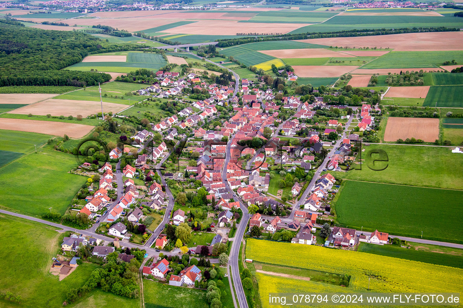 Village - view on the edge of agricultural fields and farmland in Stettbach in the state Bavaria, Germany