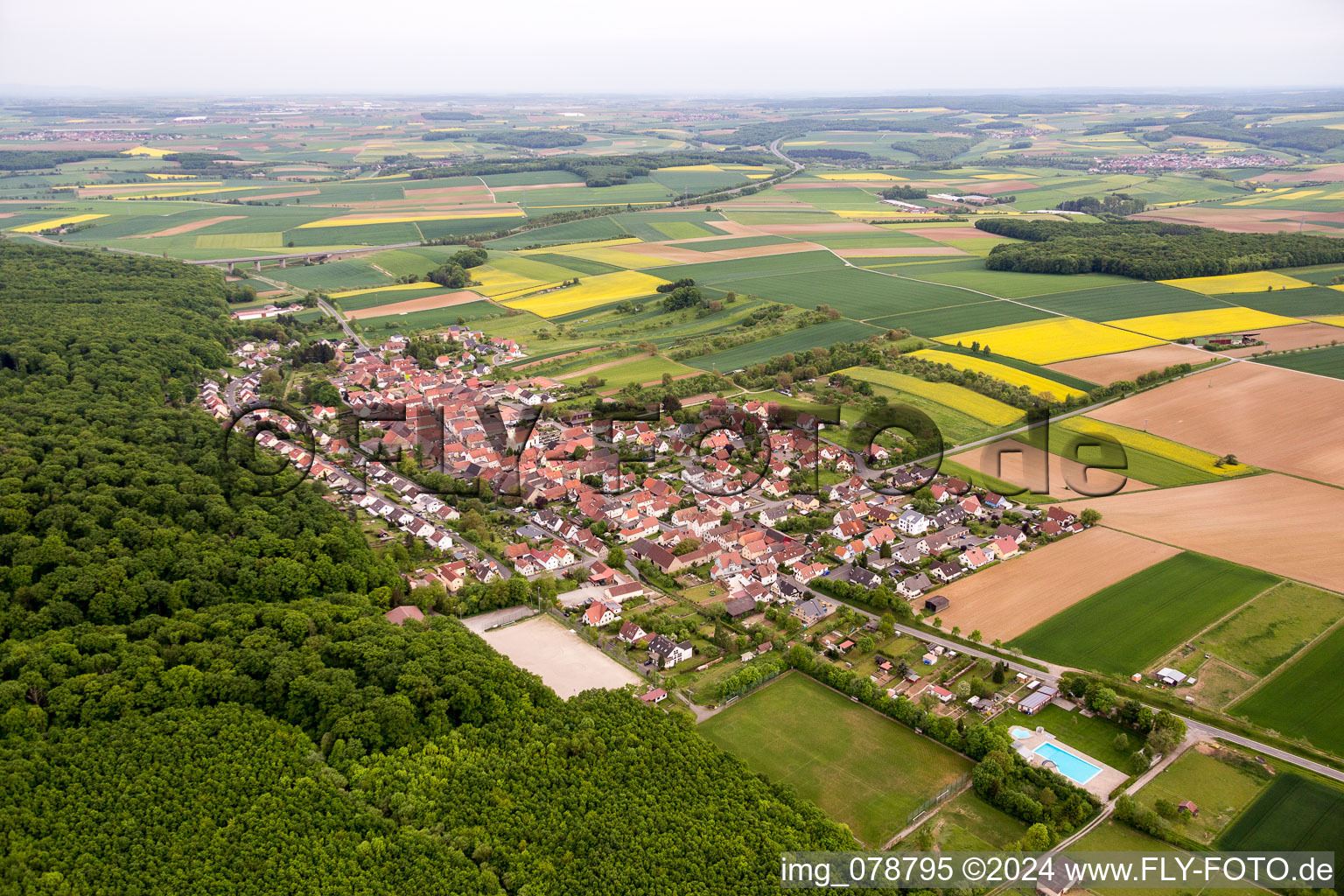 Village - view on the edge of agricultural fields and farmland in Schraudenbach in the state Bavaria, Germany