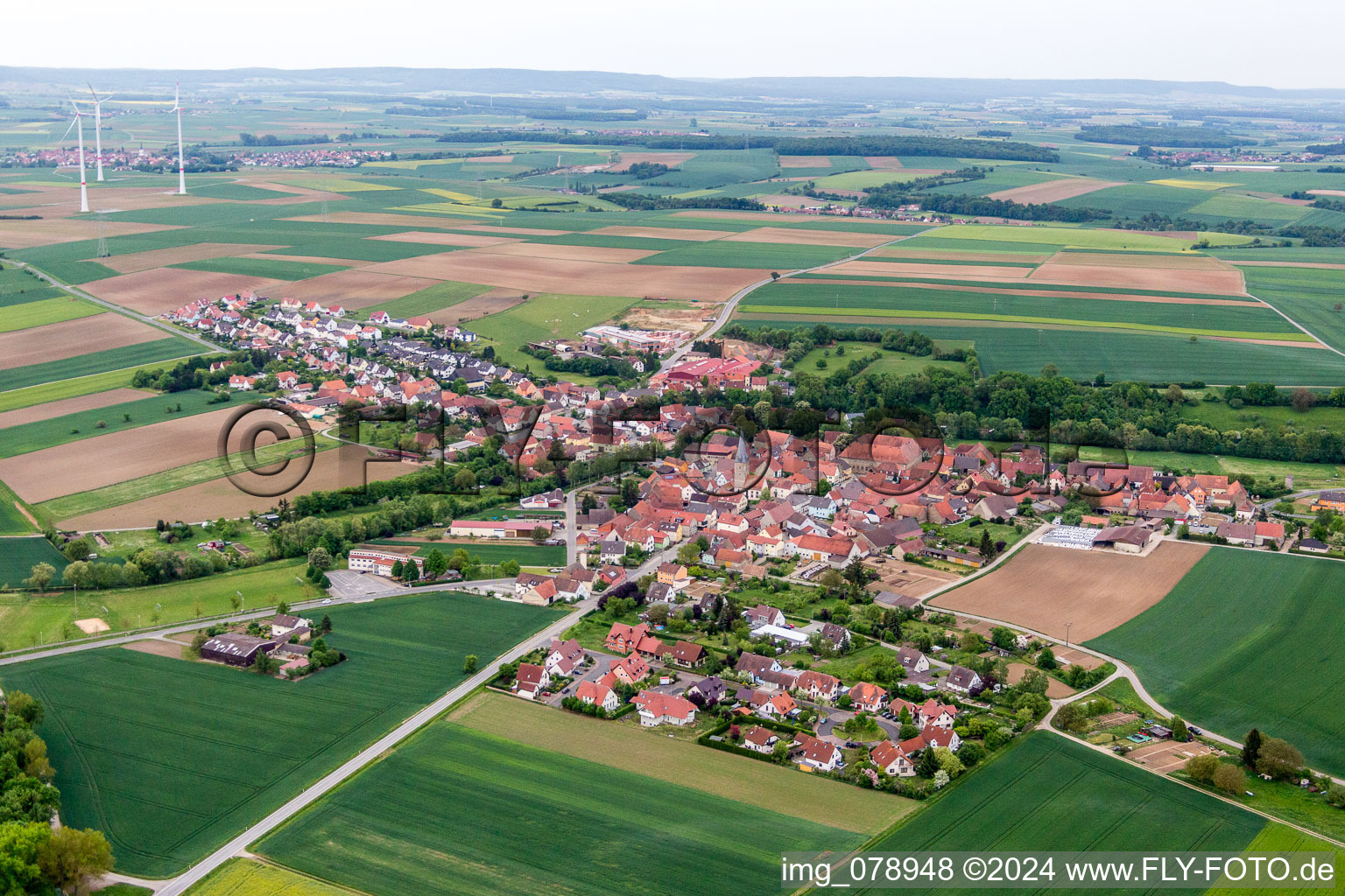 Village - view on the edge of agricultural fields and farmland in Zeilitzheim in the state Bavaria, Germany