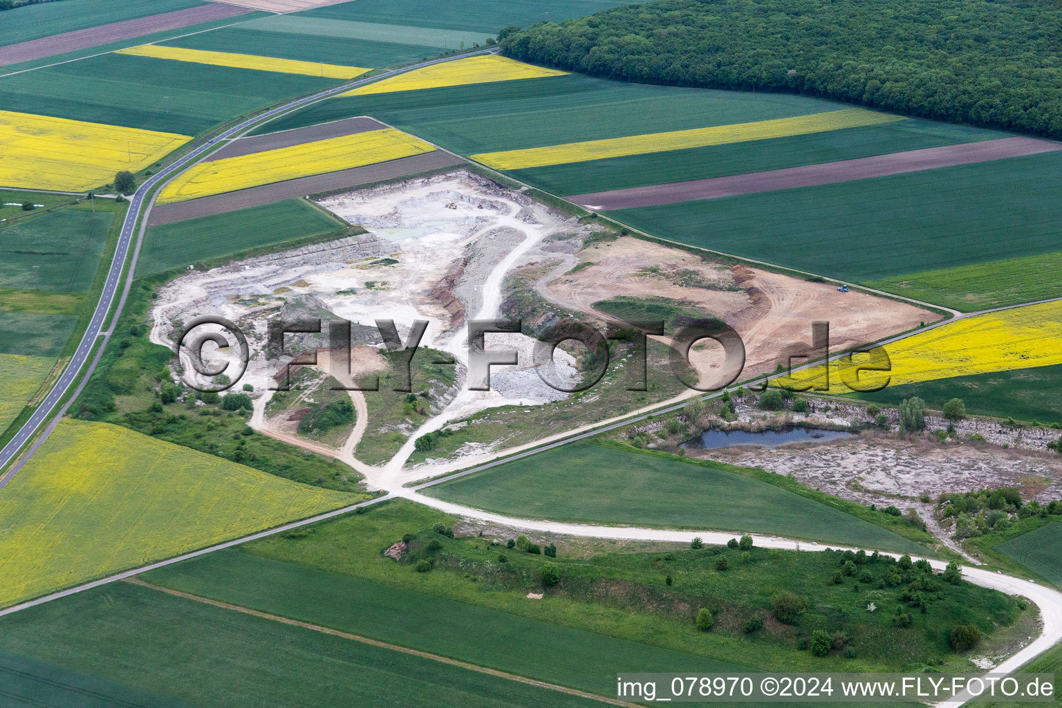 Aerial view of Site and tailings area of the gravel mining of Concrete-manufacturer in Sulzheim in the state Bavaria, Germany