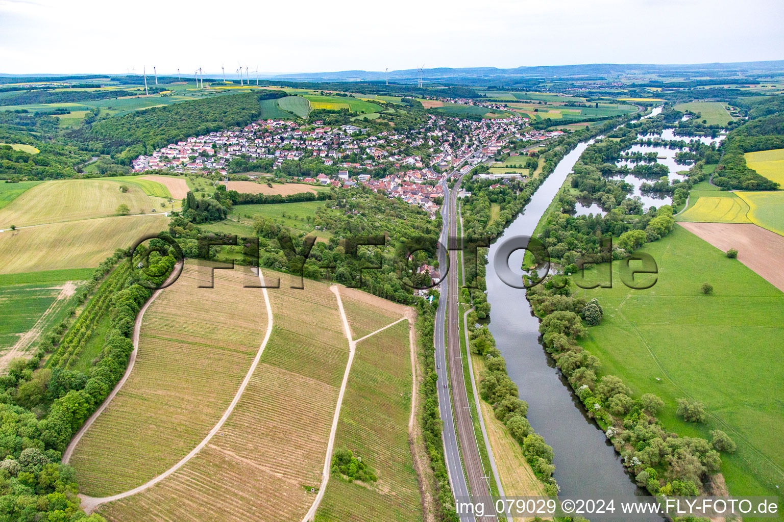 The railway and B26 lead along the banks of the Main to the southwest in Schonungen in the state Bavaria, Germany