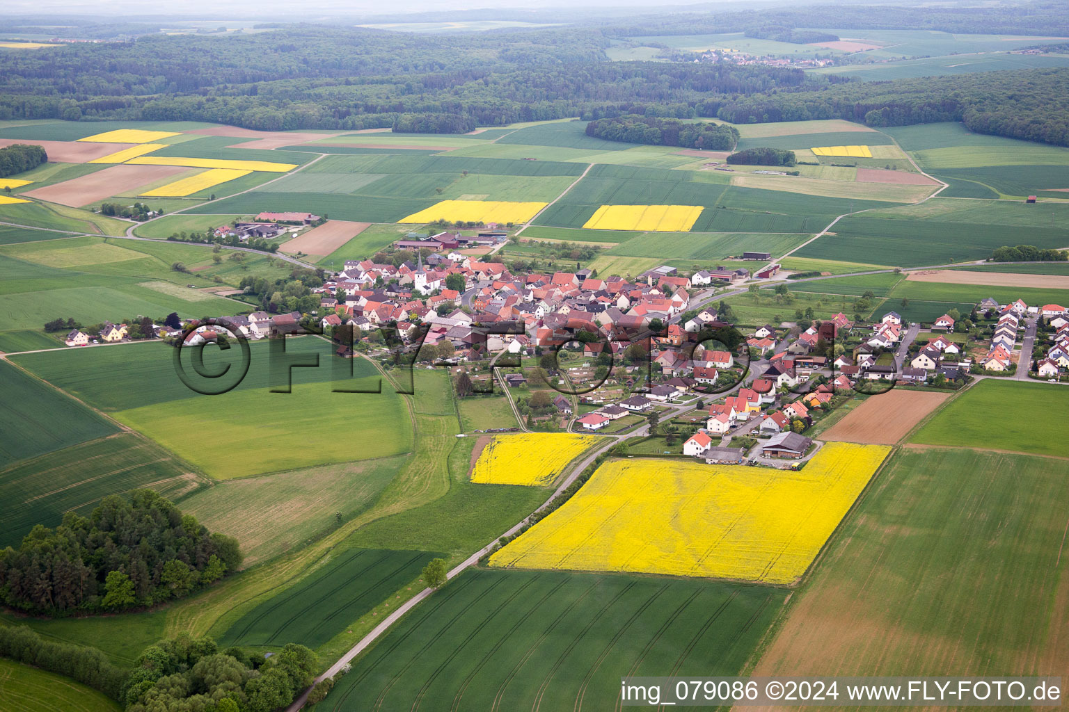 Village - view on the edge of agricultural fields and farmland in Ebertshausen in the state Bavaria