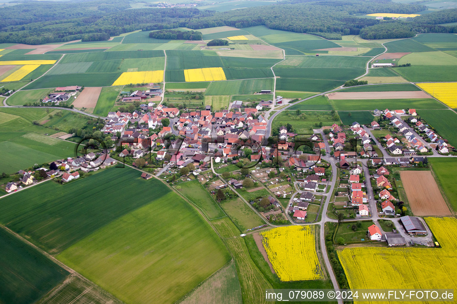 Aerial view of Village - view on the edge of agricultural fields and farmland in Ebertshausen in the state Bavaria