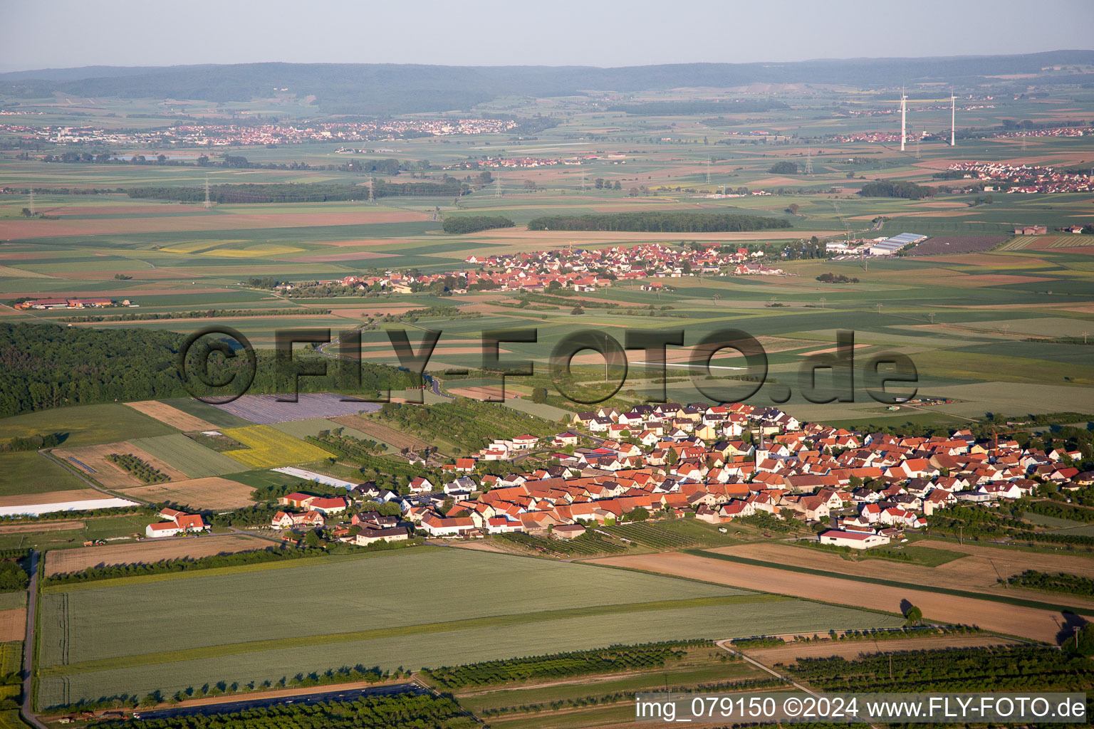 Aerial view of Village - view on the edge of agricultural fields and farmland in the district Theilheim in Waigolshausen in the state Bavaria, Germany