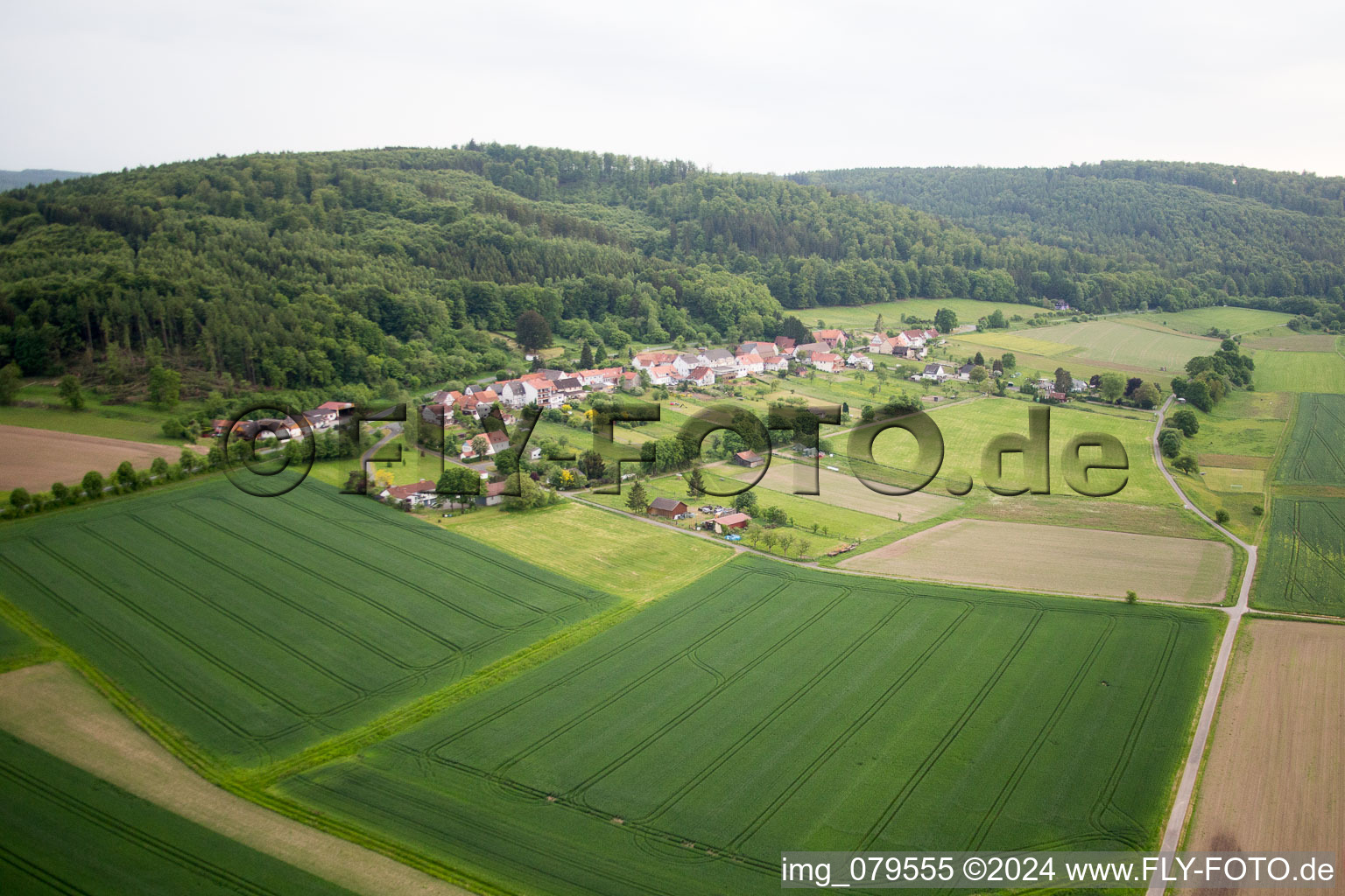 Village - view on the edge of agricultural fields and farmland in Oberweser in the state Hesse, Germany