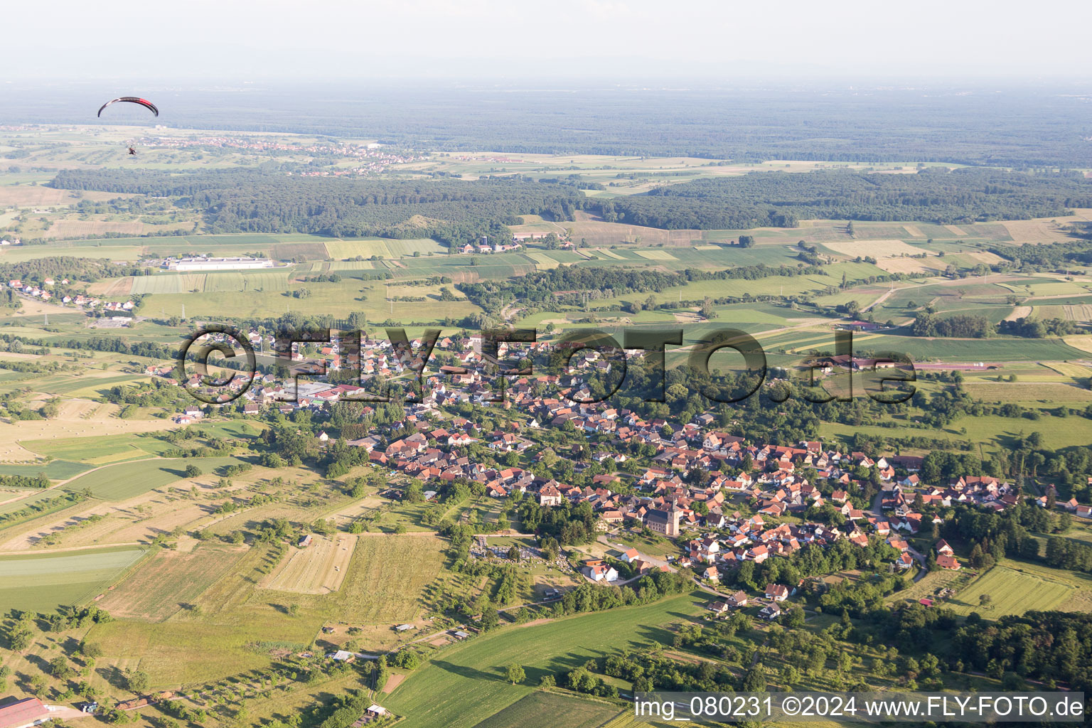 Village - view on the edge of agricultural fields and farmland in Preuschdorf in Grand Est, France