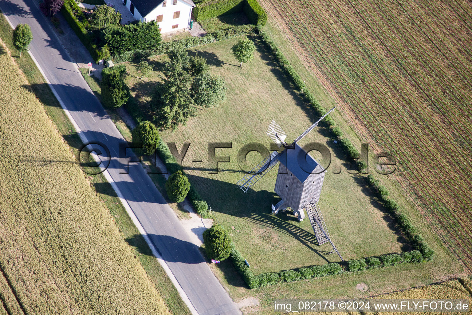 Historic windmill on a farm homestead on the edge of cultivated fields in Talcy in Centre-Val de Loire, France