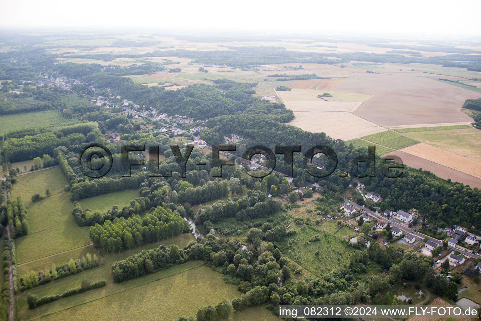 Hot air balloon launch in front of Chateau de Perreux in Nazelles-Negron in Centre-Val de Loire, France