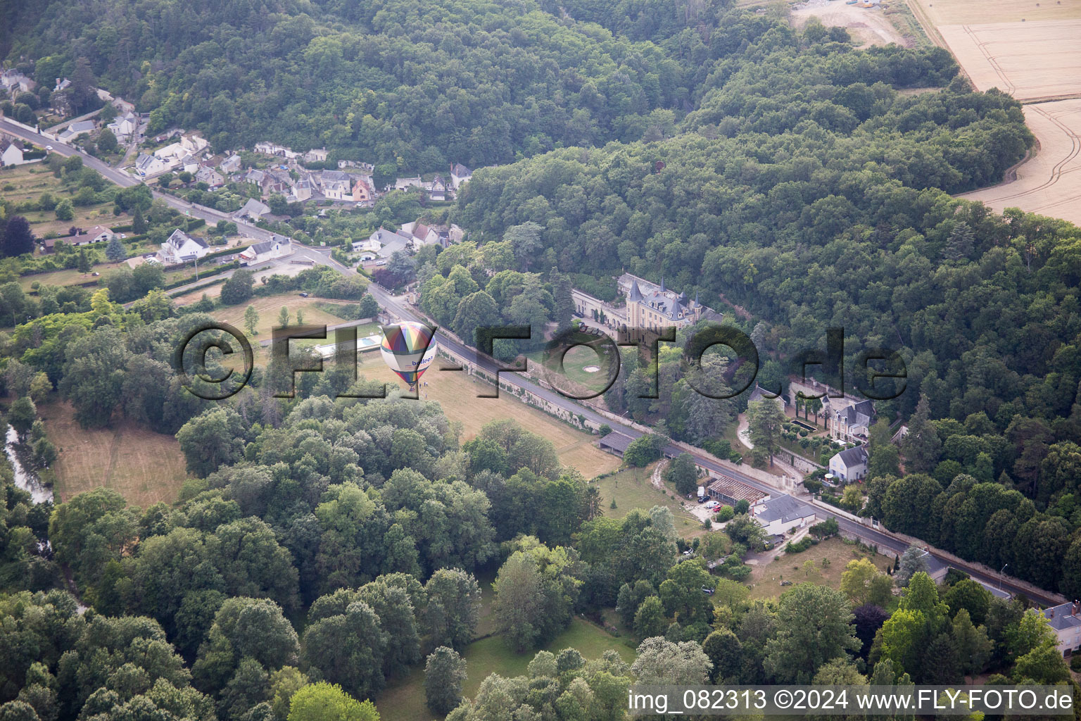 Aerial view of Hot air balloon launch in front of Chateau de Perreux in Nazelles-Negron in Centre-Val de Loire, France