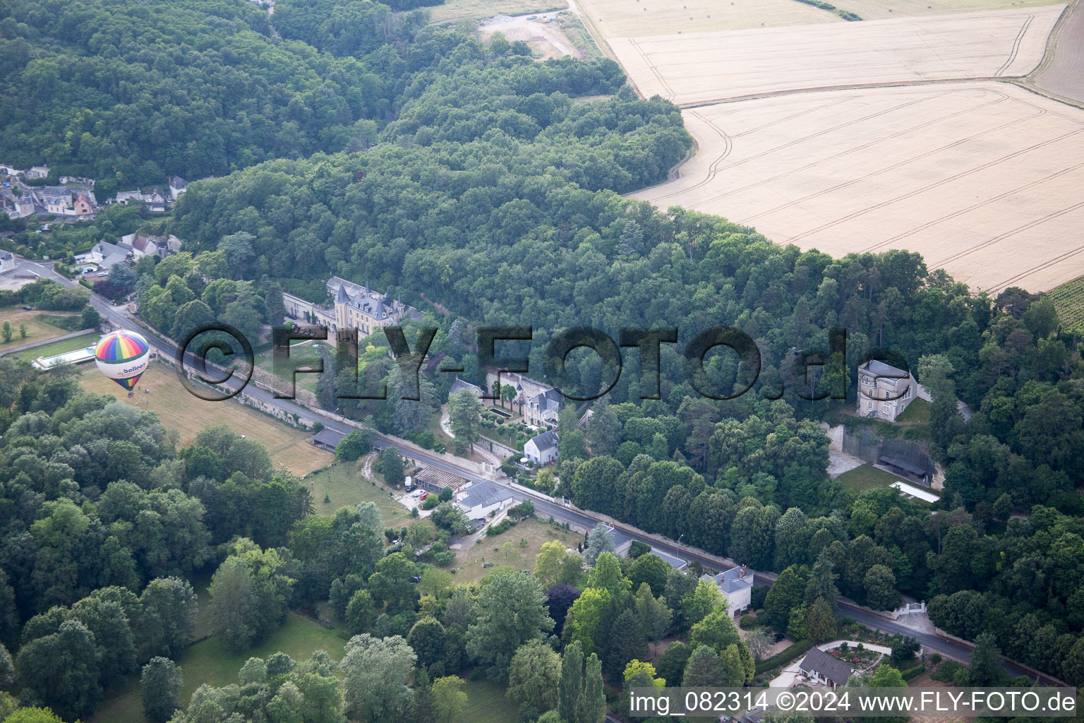 Aerial photograpy of Hot air balloon launch in front of Chateau de Perreux in Nazelles-Negron in Centre-Val de Loire, France