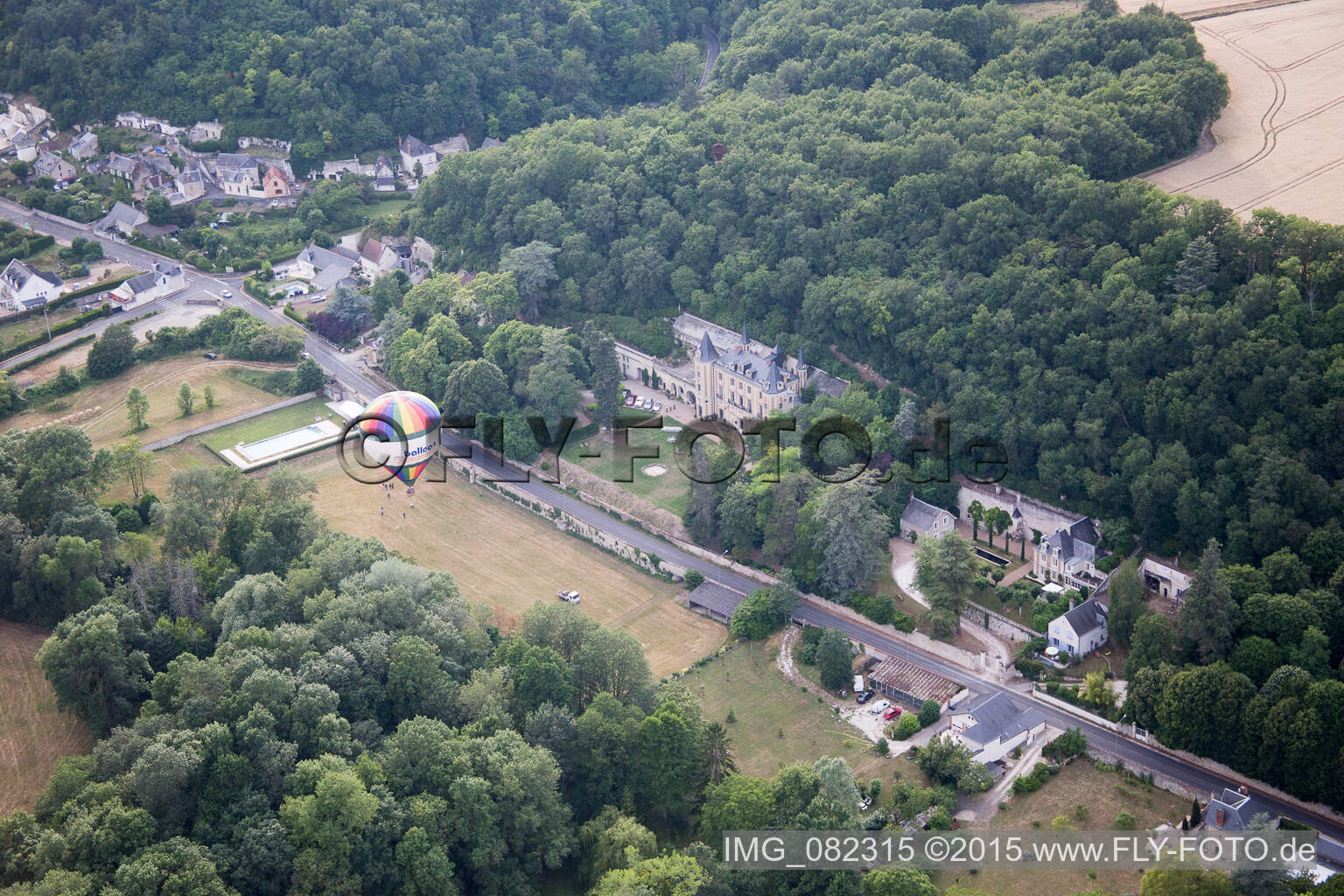 Oblique view of Hot air balloon launch in front of Chateau de Perreux in Nazelles-Negron in Centre-Val de Loire, France