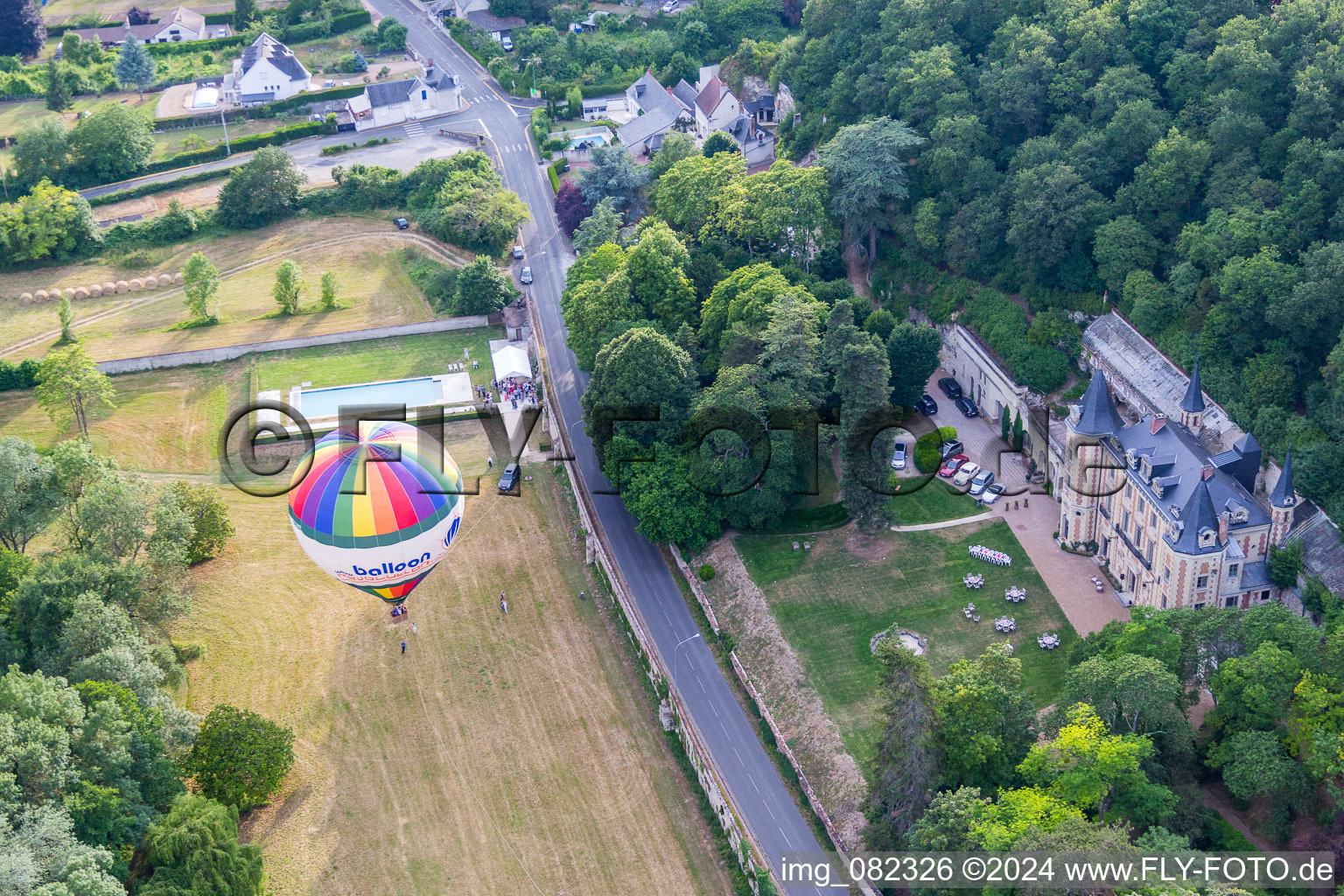 Aerial view of Hot air balloon start on Chateau de Perreux flying over the airspace in Nazelles-Negron in Centre-Val de Loire, France