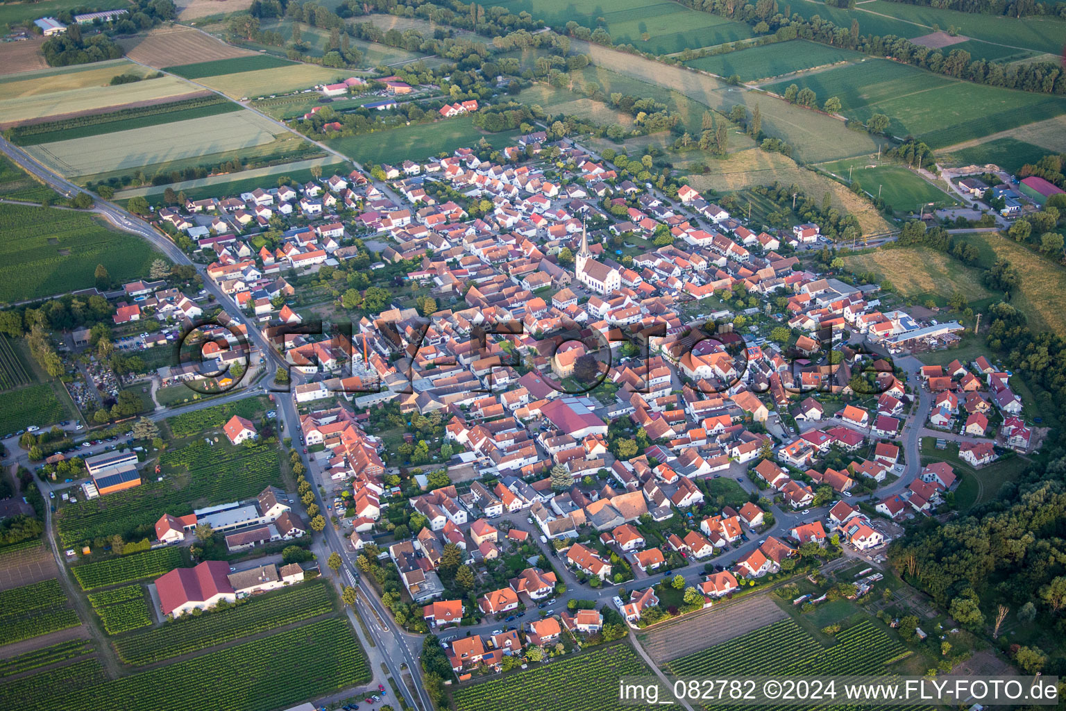 Oblique view of Village - view on the edge of agricultural fields and farmland in Venningen in the state Rhineland-Palatinate, Germany