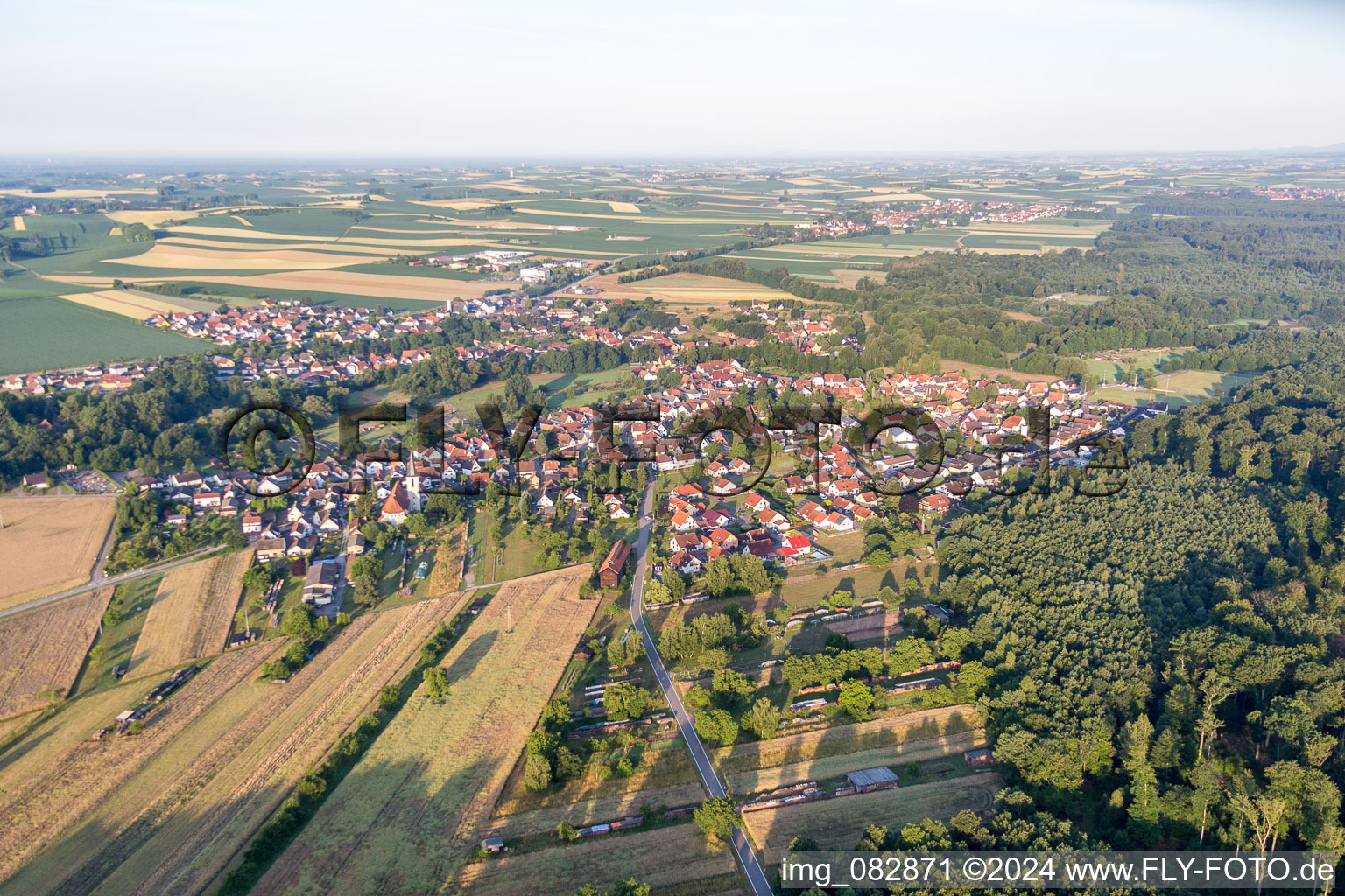 Village - view on the edge of agricultural fields and farmland in Scheibenhardt in the state Rhineland-Palatinate, Germany